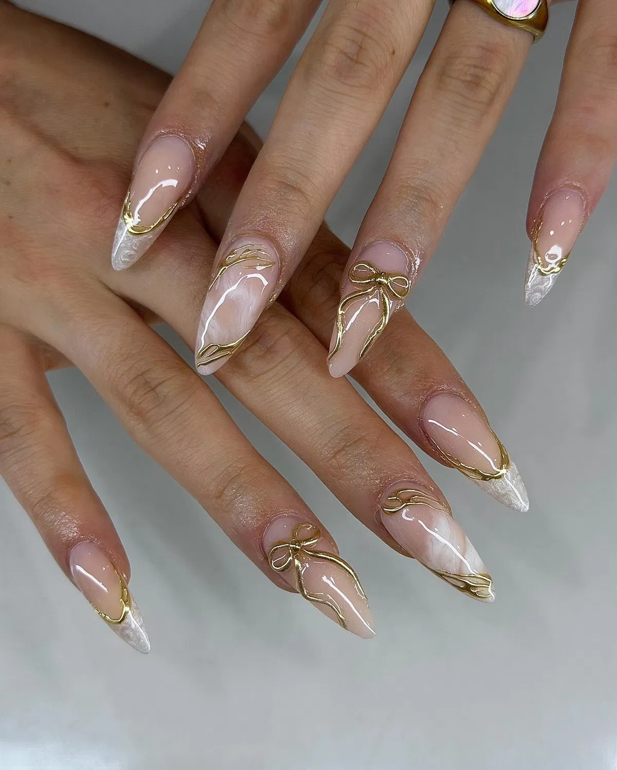 Marbled white tips with gold outlines and raised bows
