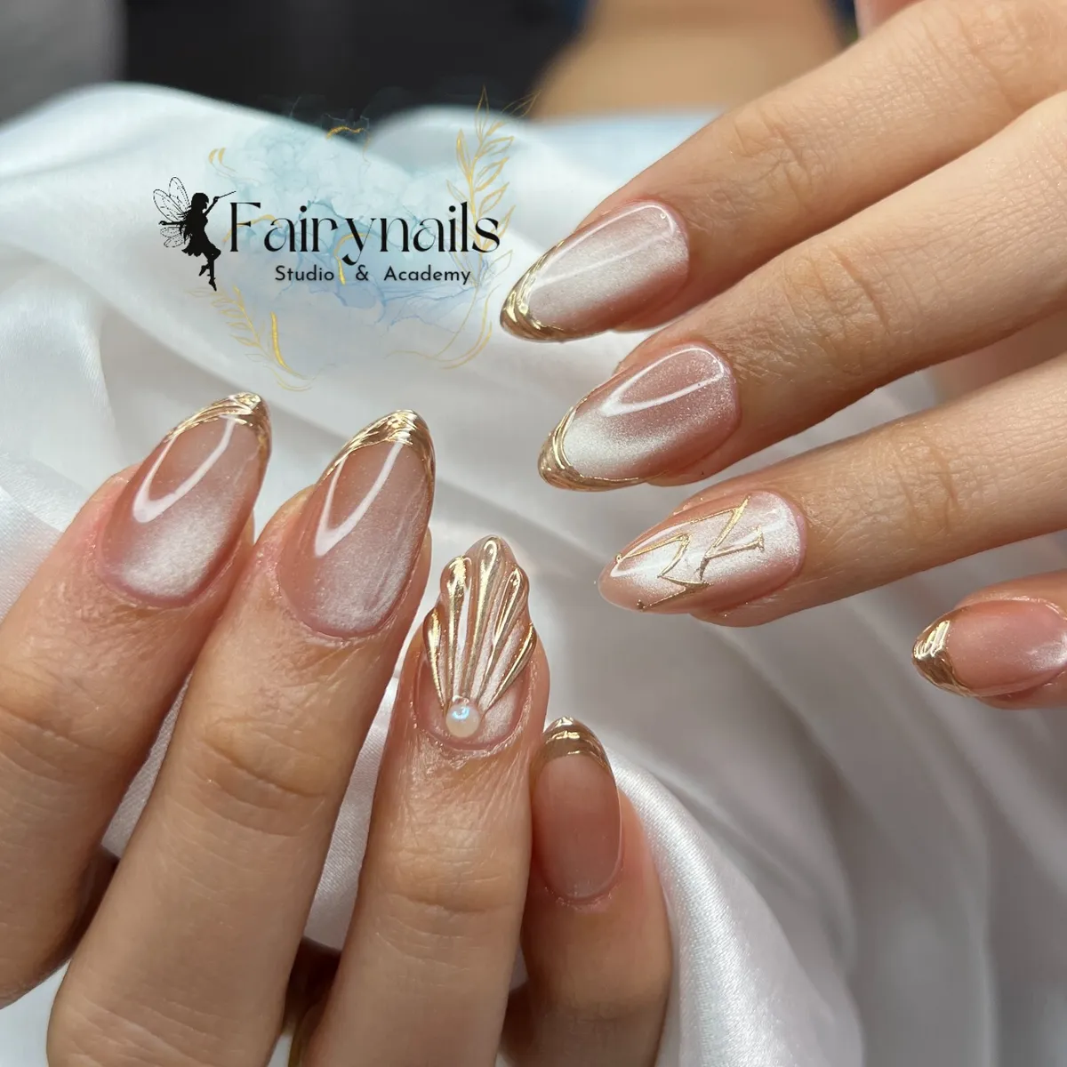 Sheer Nude Almond Nails with Thin Gold Tips and Shell Accent