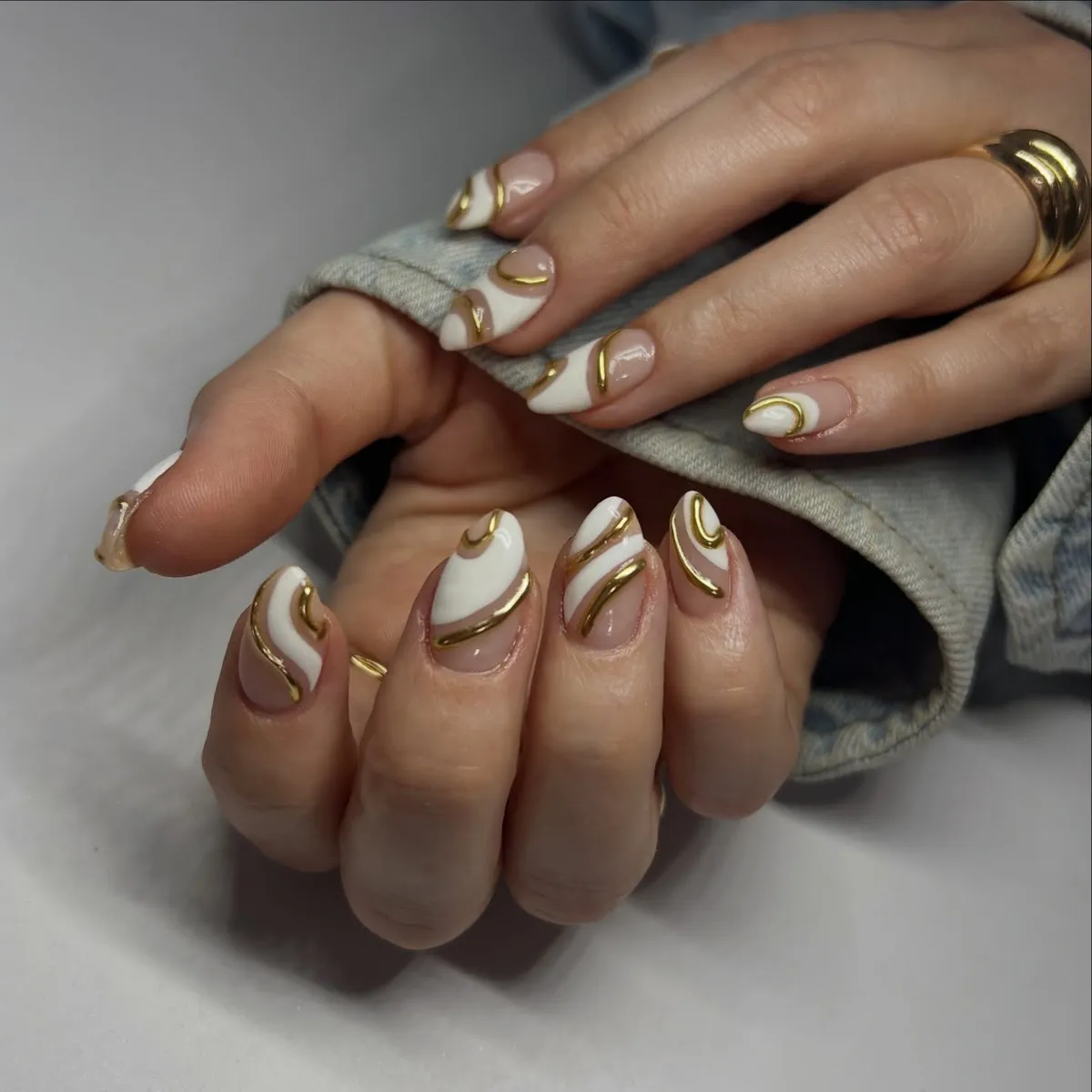 Short Nude Nails with White Waves and Gold Swirl Lines