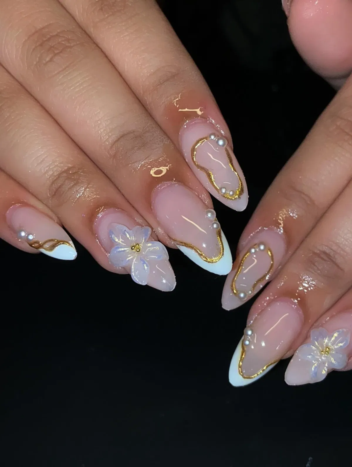 Gold-outlined French with pearl-like beads and a 3D flower