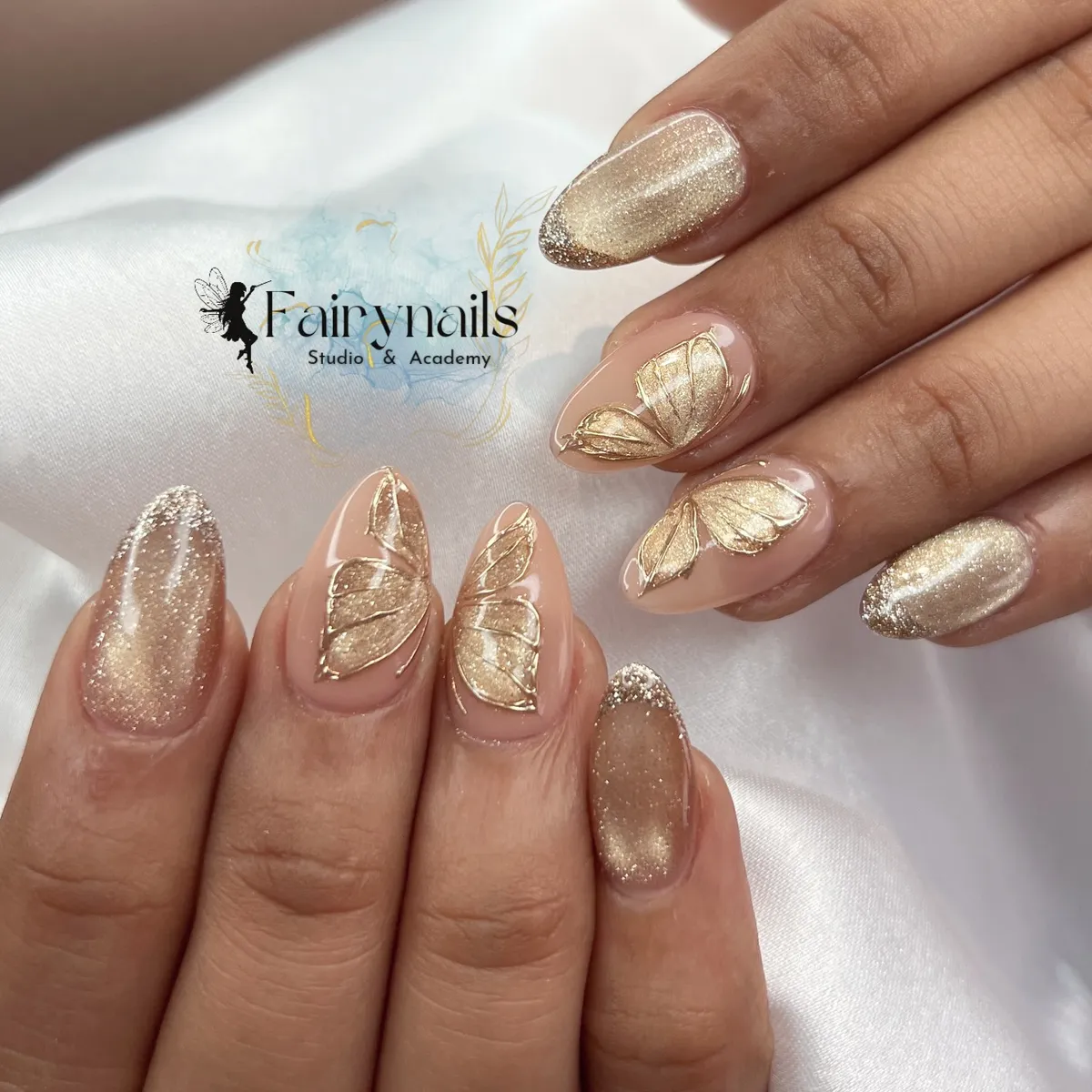 Champagne shimmer nails with raised gold leaf accents