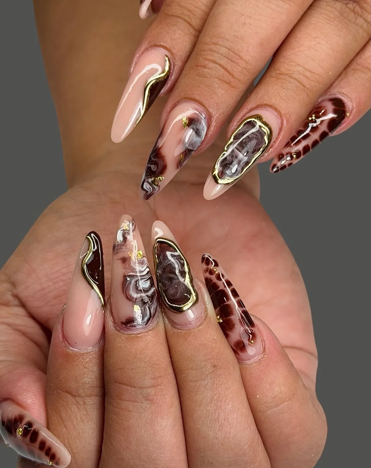 Brown marbling with gold outline framing and studs