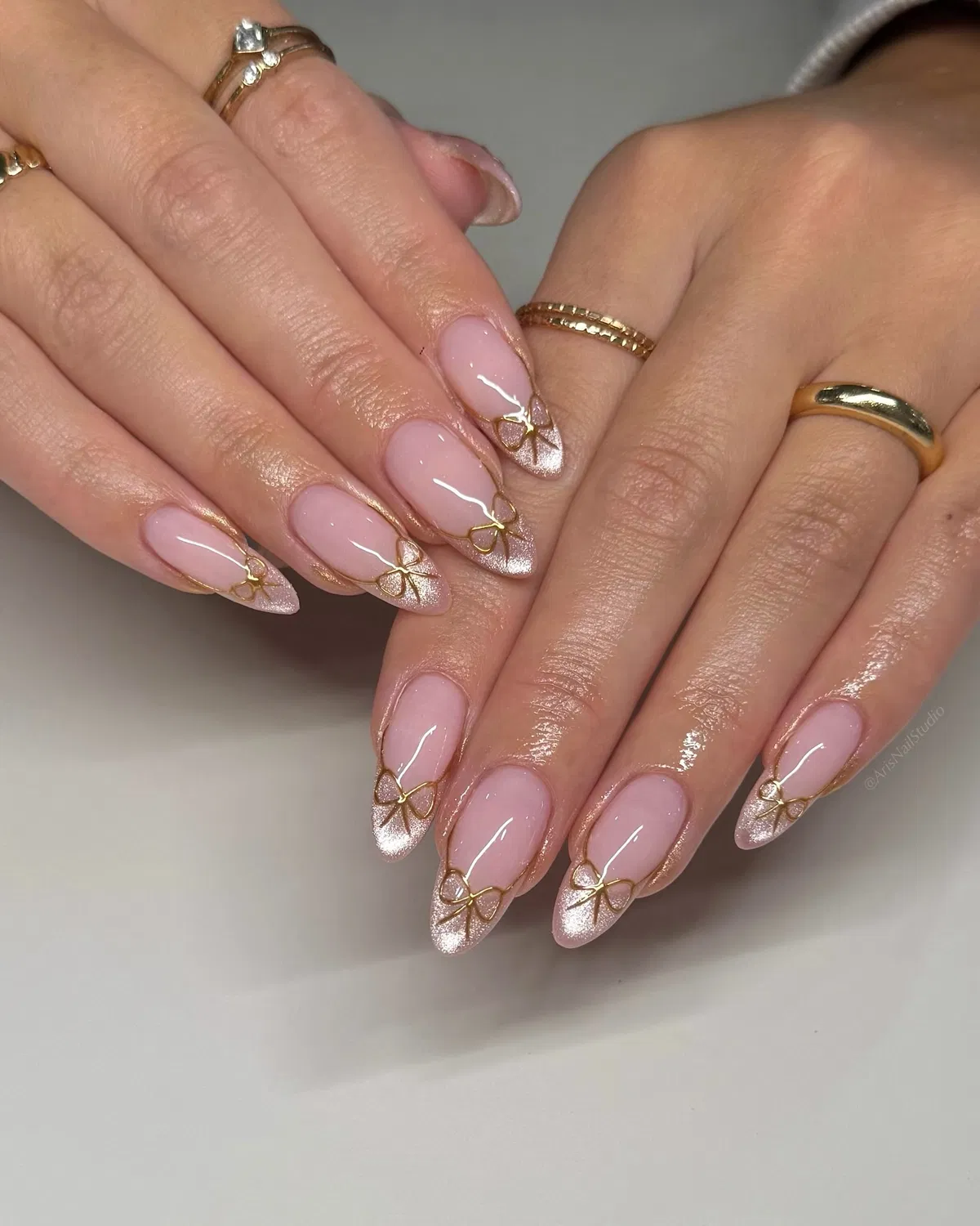 Shimmery tips with delicate gold bow outlines