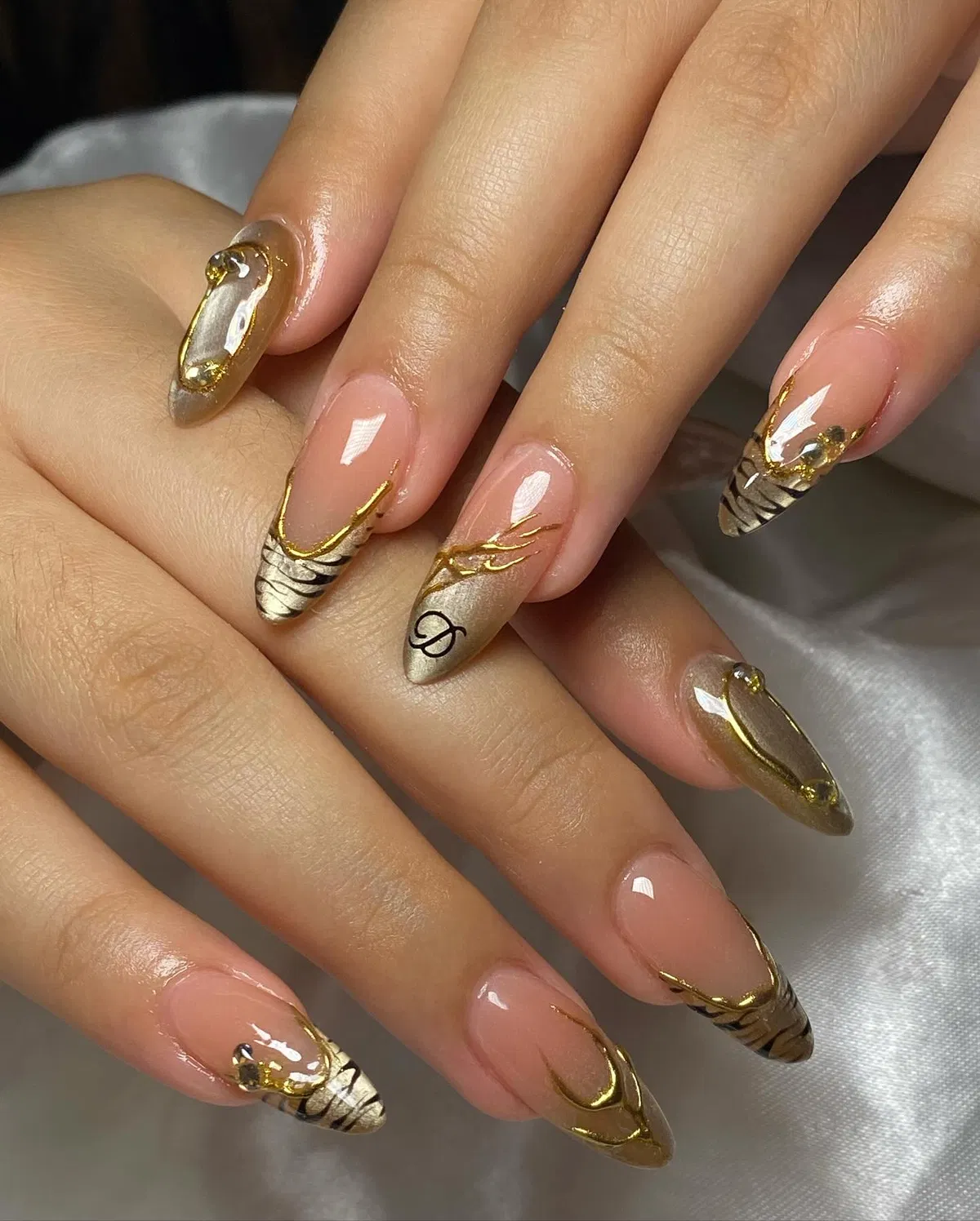 Gold-and-black zebra tips with logo-style accent