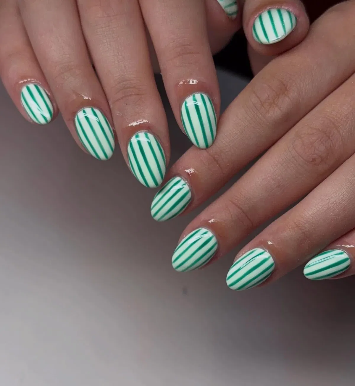 White base with thin vertical green striping (no plaid visible)