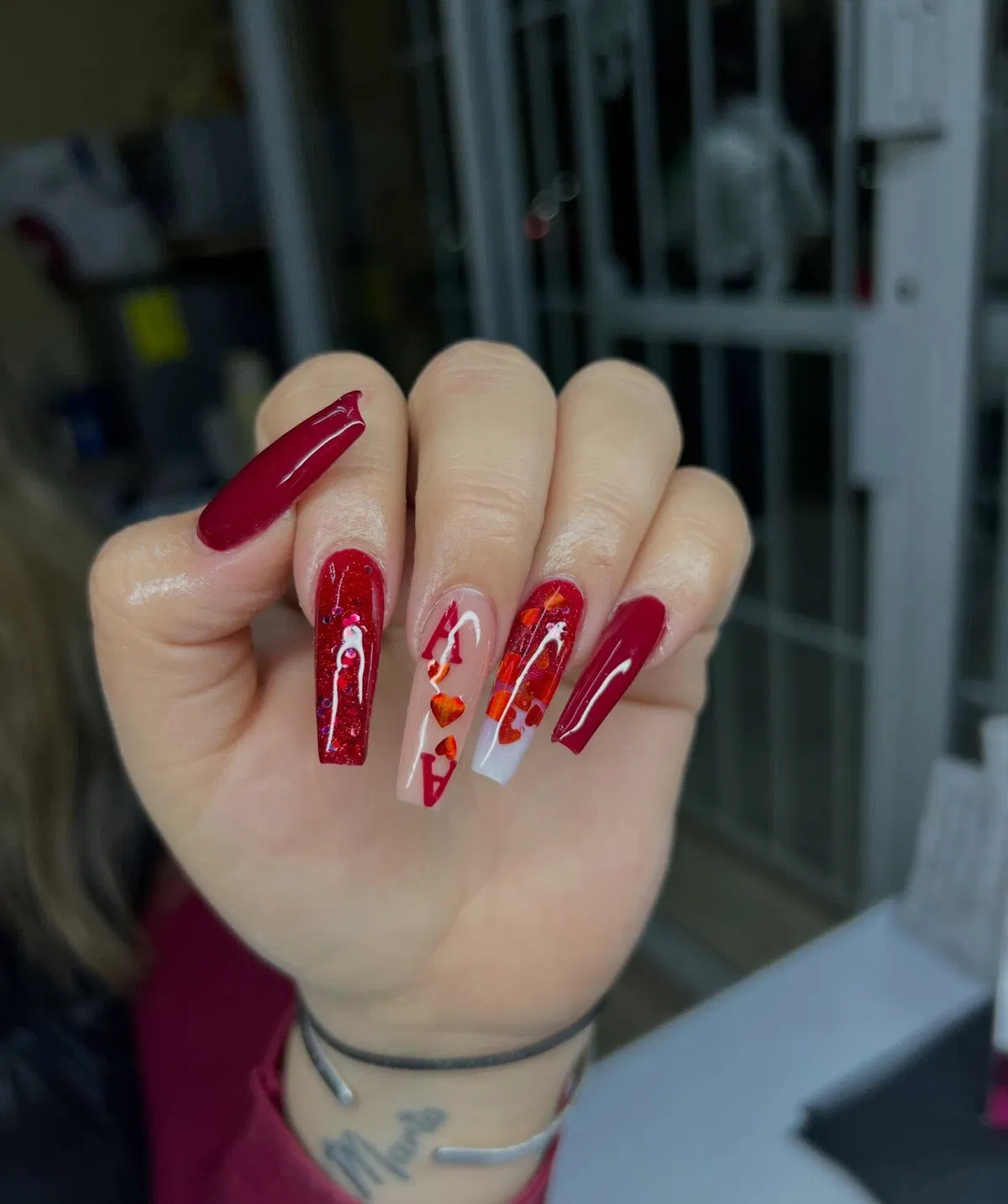 Deep red coffin nails with translucent accents and embedded-color fragments