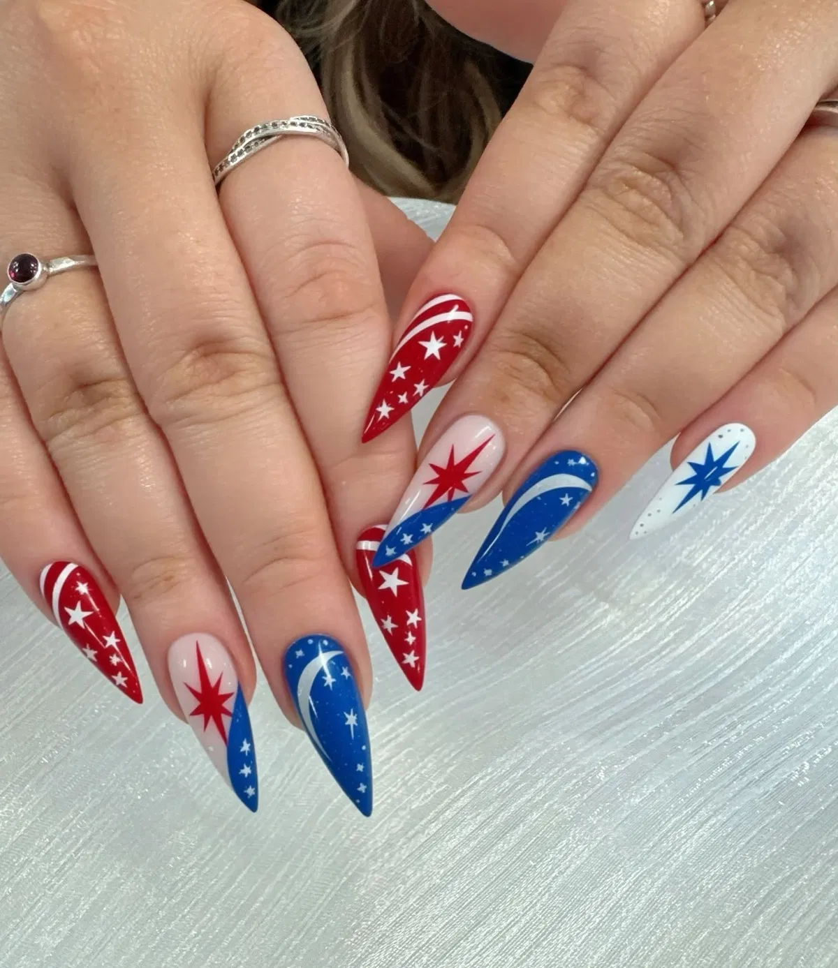 Red-and-blue star graphic long pointed nails