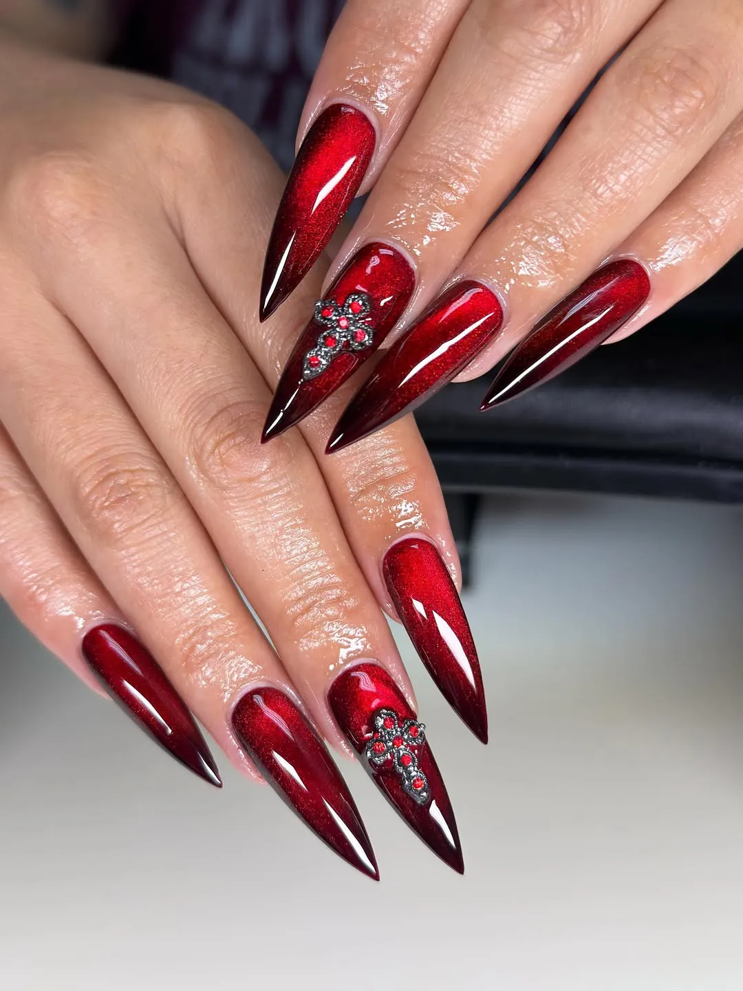 Dark red gradient stilettos with rhinestone cross accents