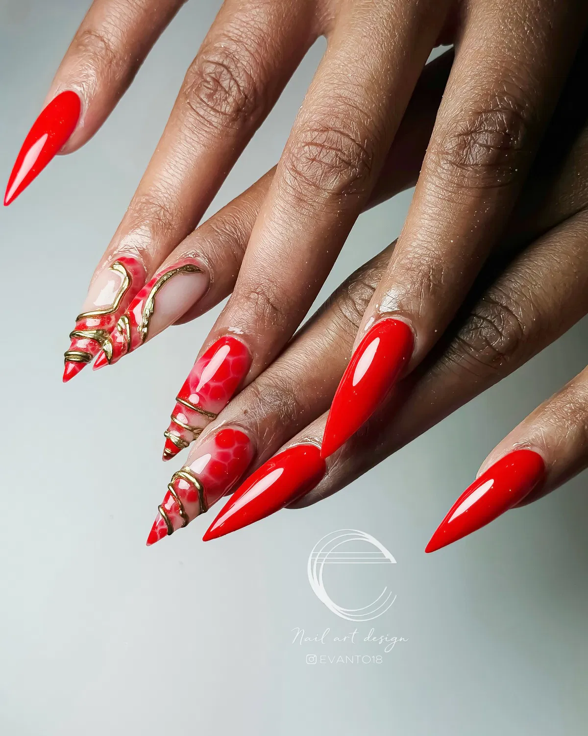 Bright red stilettos with gold linework and marbled accents