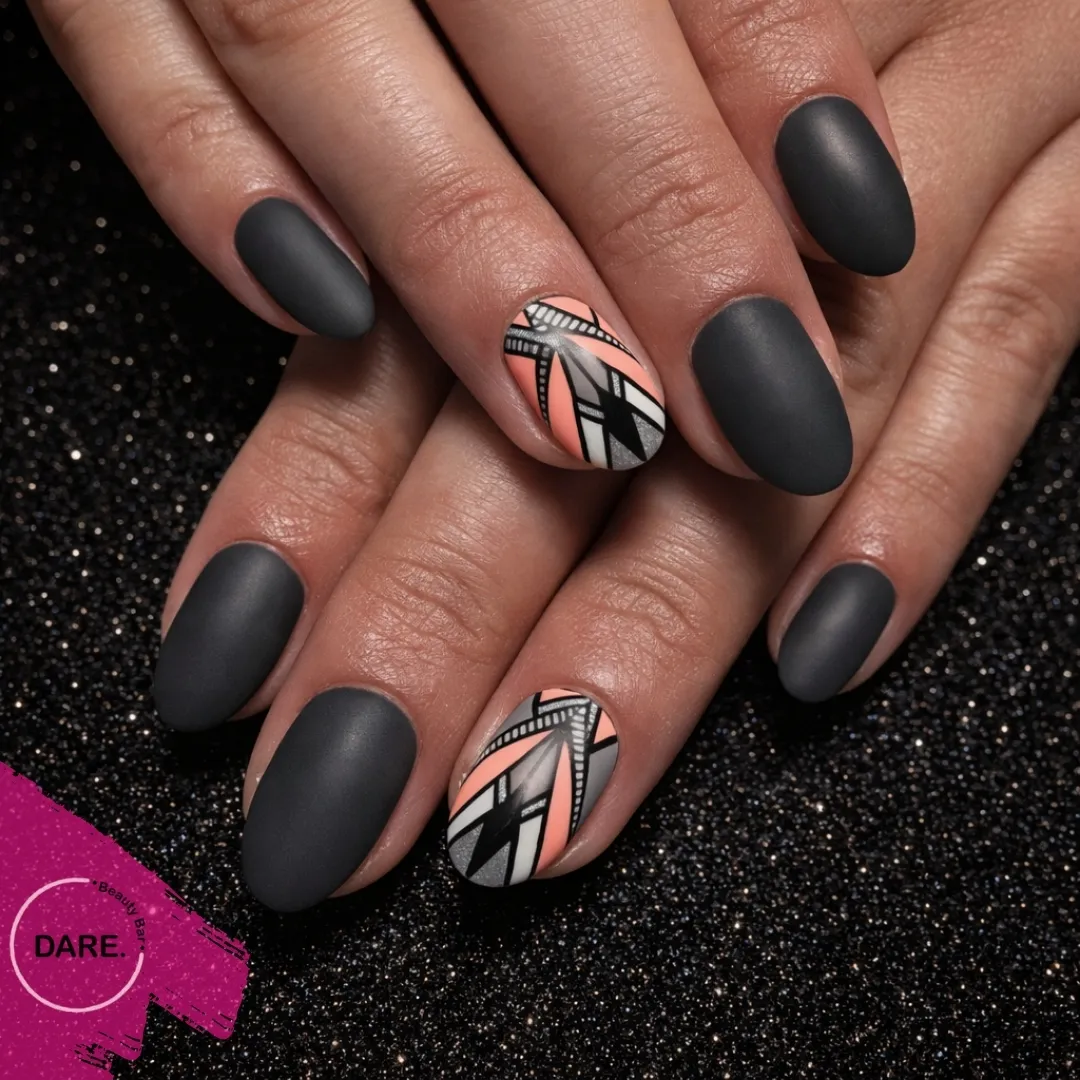 Matte charcoal nails with peach-and-monochrome geometric accents