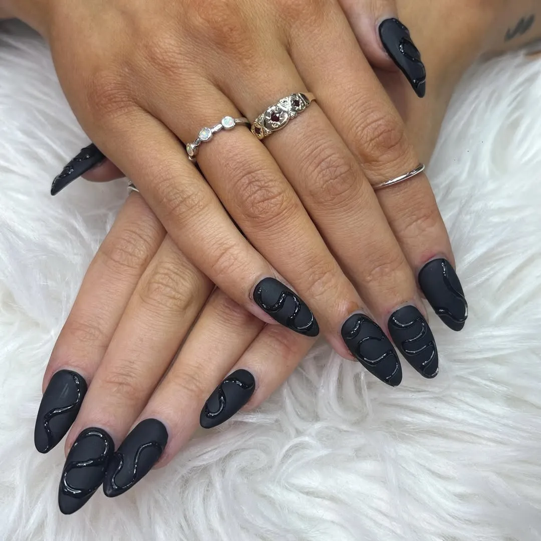Matte black nails with raised glossy swirl linework