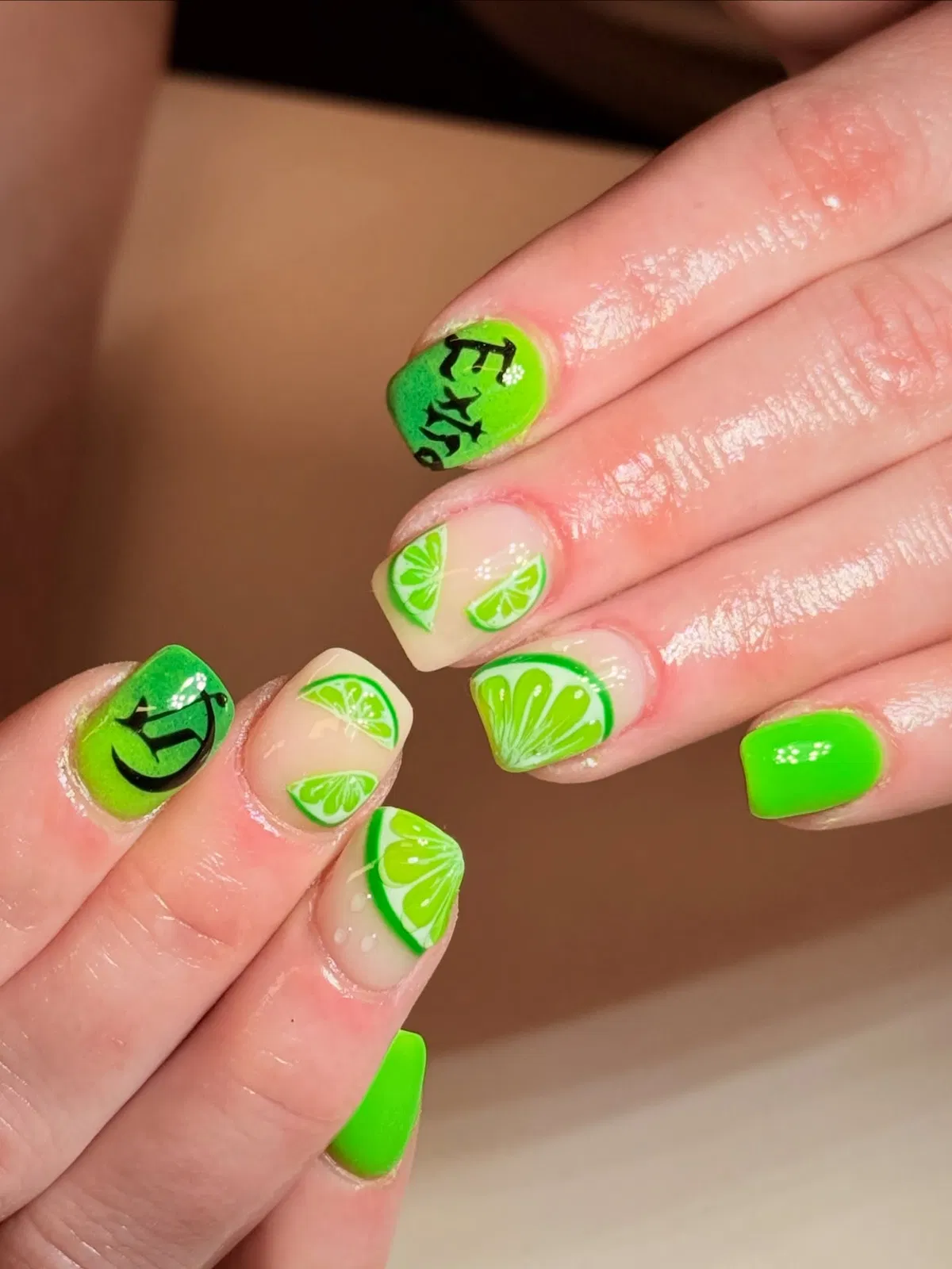 Lime-slice nail art with neon green solids and black lettering