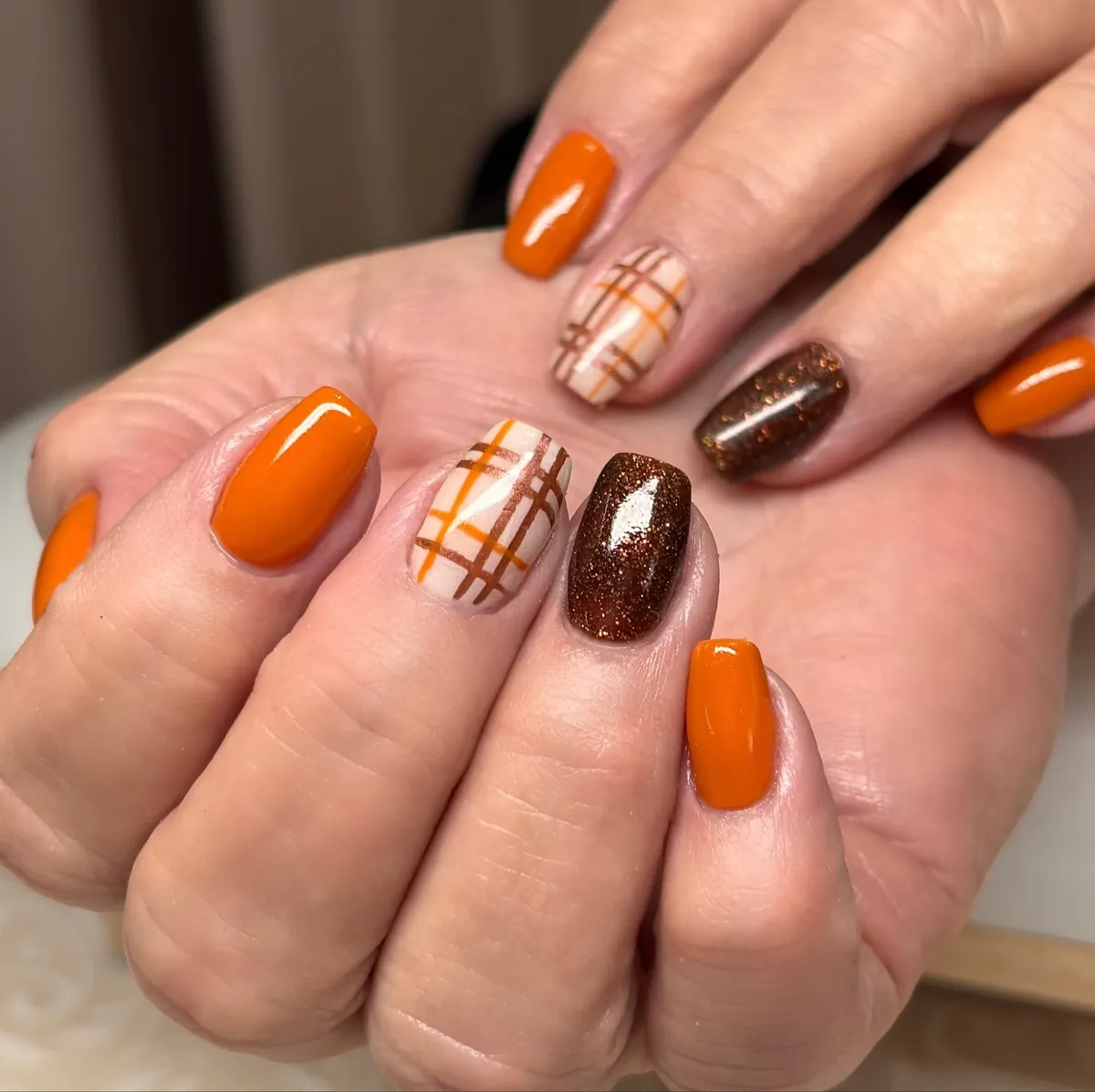 Bright orange with nude plaid and brown sparkle accent