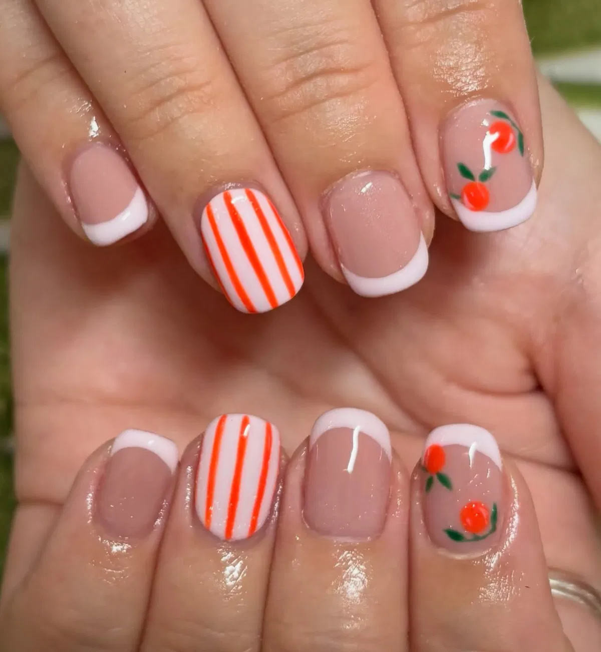 French tips with orange stripes and small fruit accents