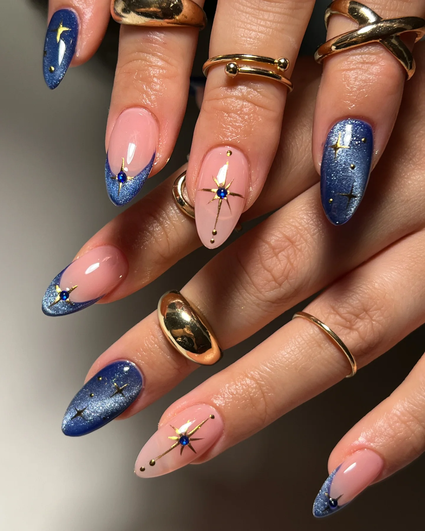 Deep blue glitter with gold starbursts on nude base