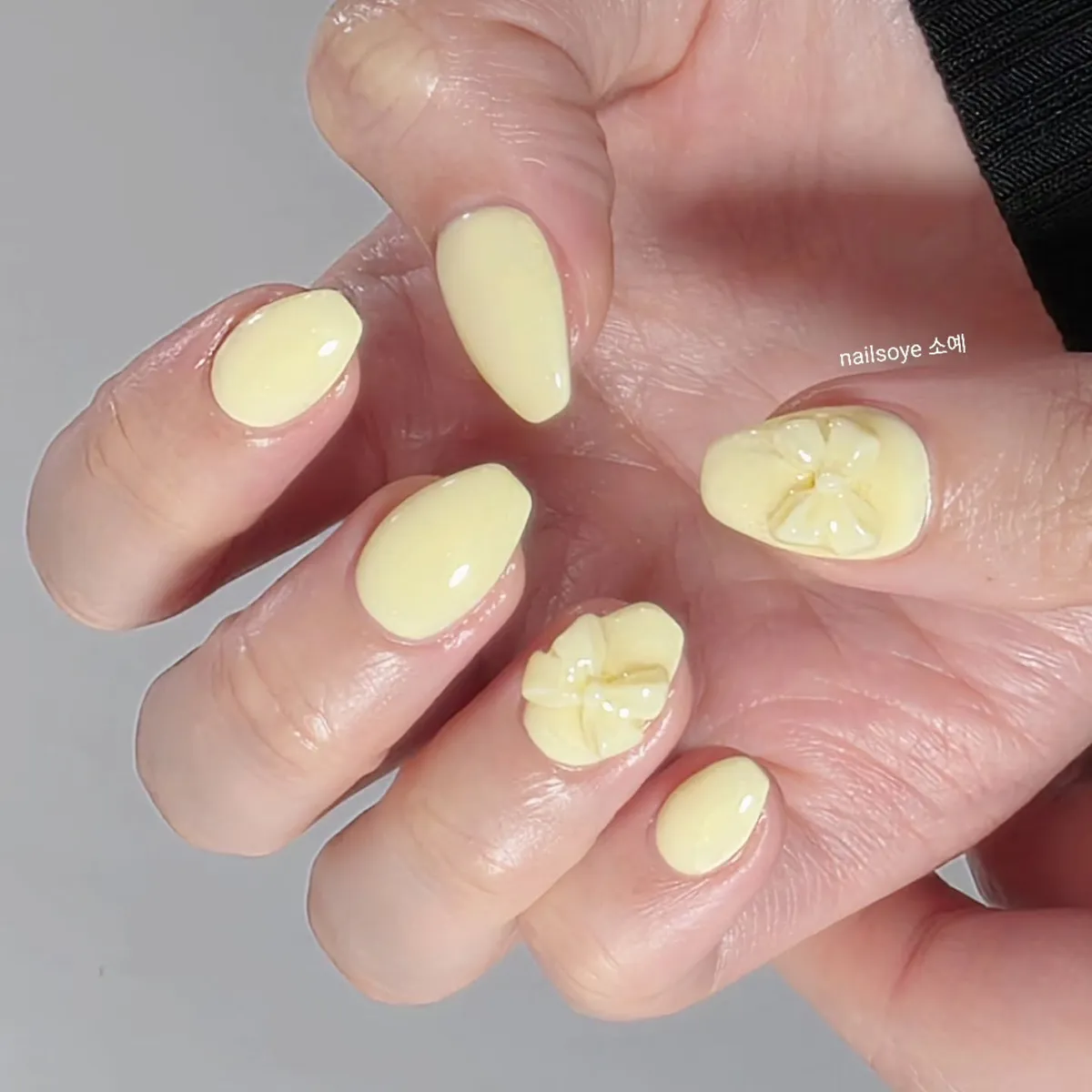 Glossy pale yellow with raised floral accents