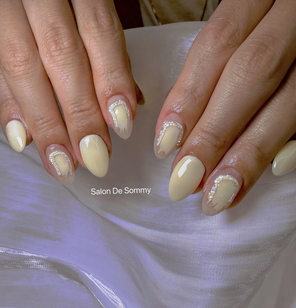 Creamy pale yellow with curved iridescent glitter outlines