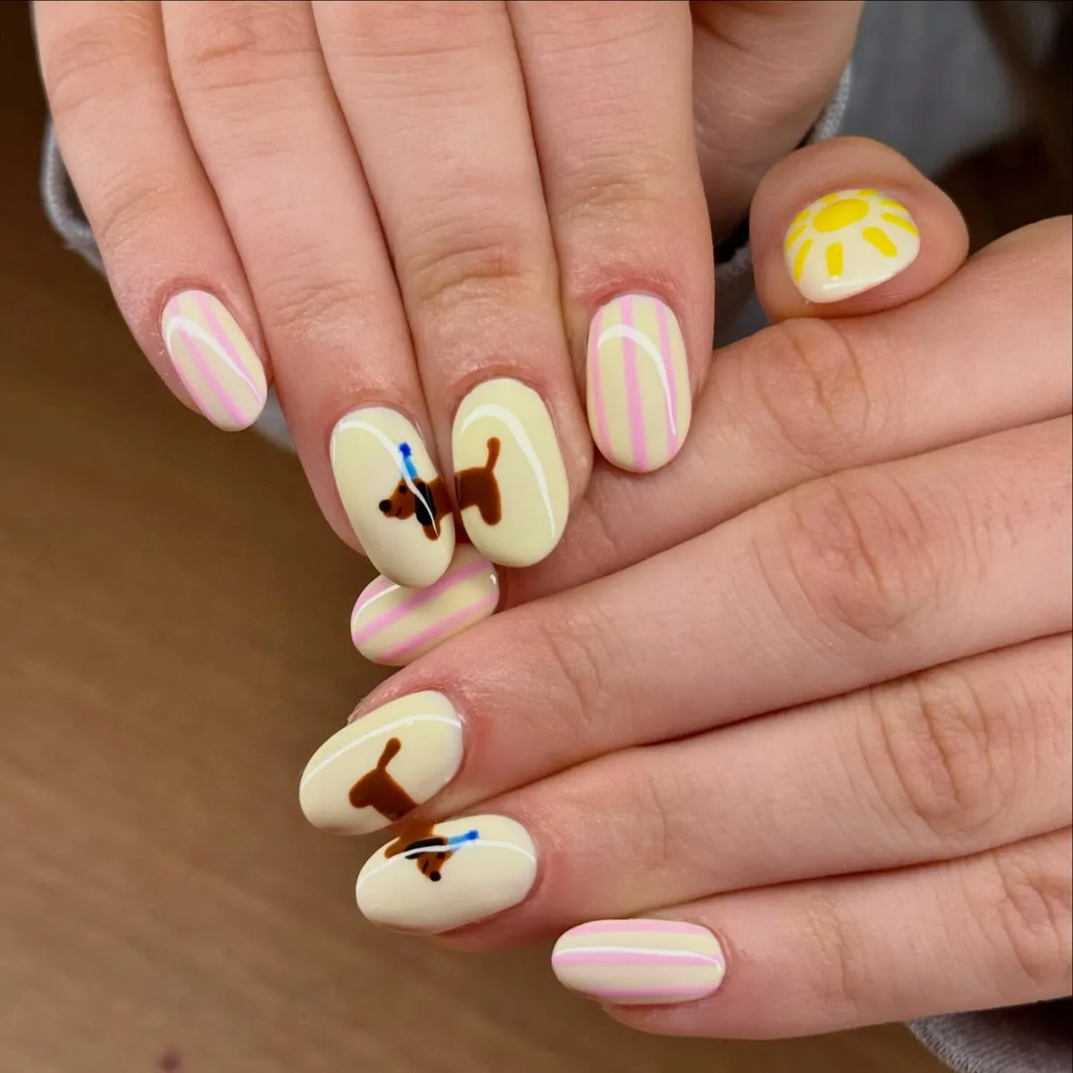 Creamy pastel yellow with pink stripes and small graphic accents
