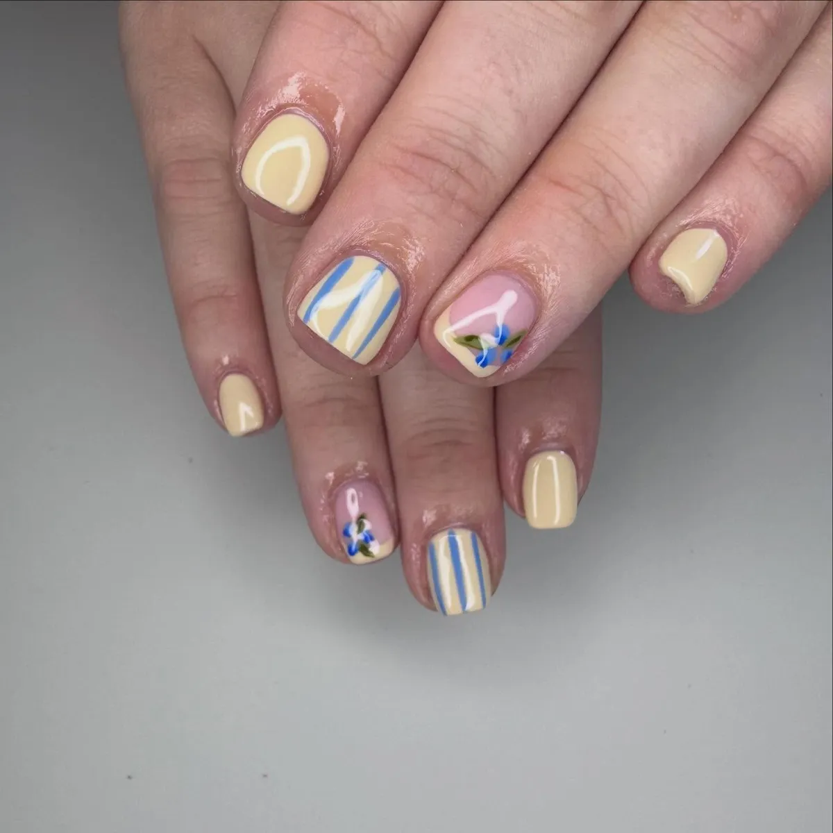 Pale yellow with blue stripes and tiny floral accents