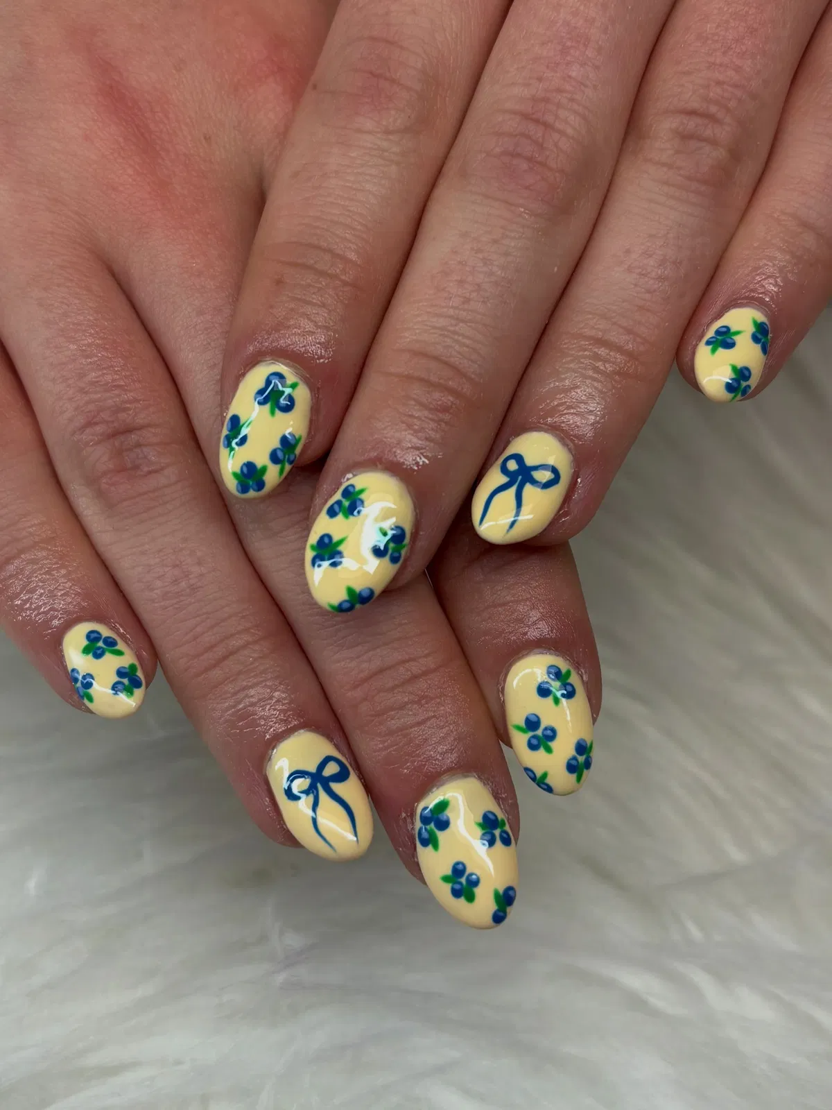 Pastel yellow with blue-and-green berry pattern and bows