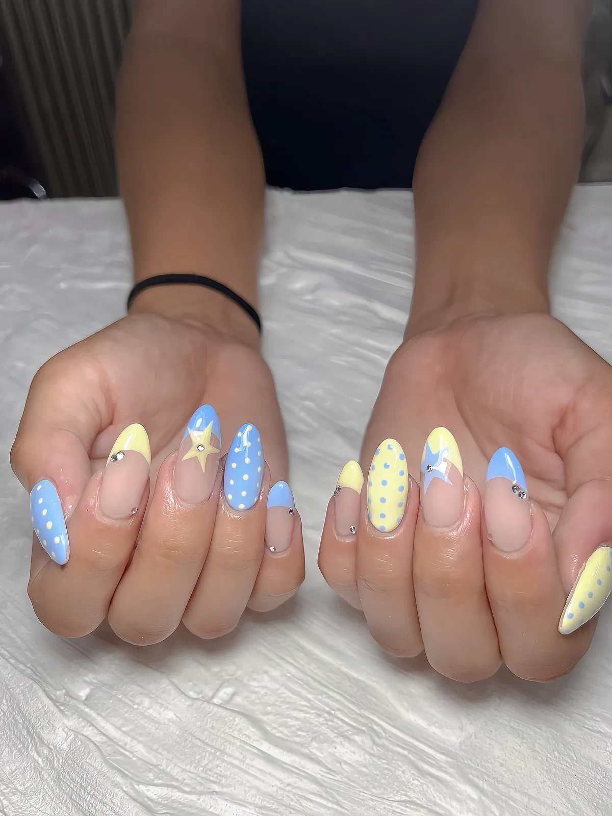 Pastel yellow and blue with stars, dots, and studs