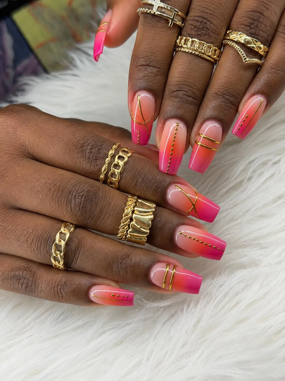 Pink ombrΓ© coffin nails with gold linework and stud rows
