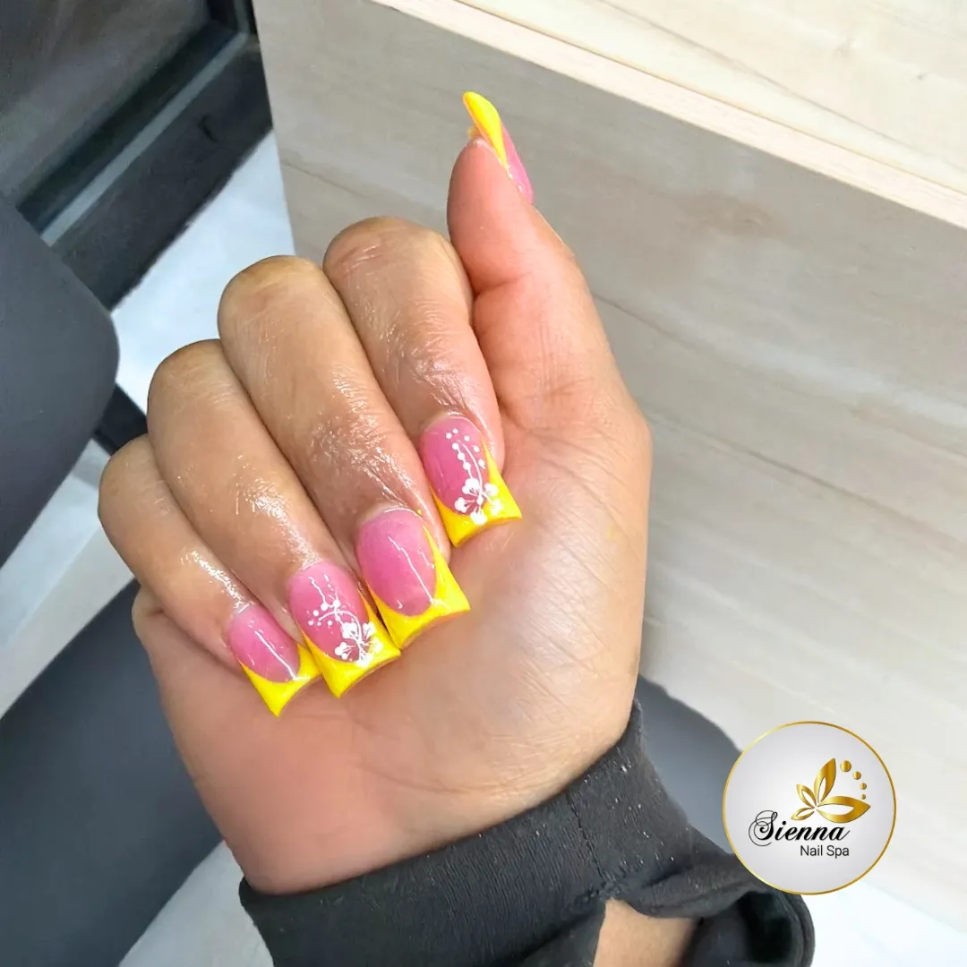 Pink Base with Bright Yellow French Tips and White Floral Lines