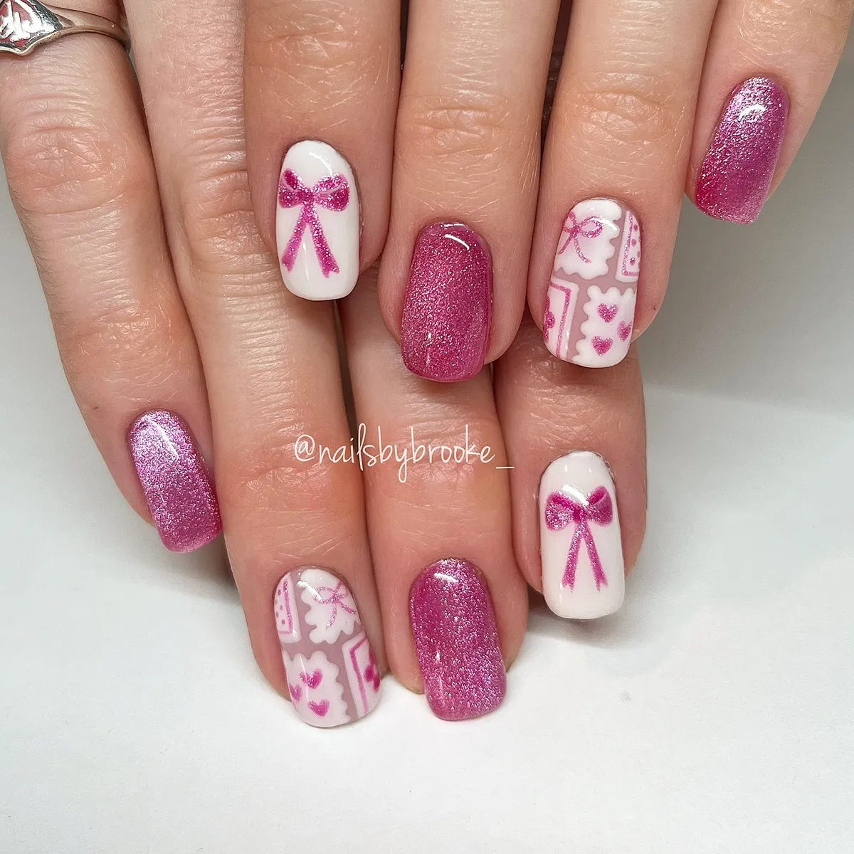 Pink glitter set with bow and heart-style line art on white