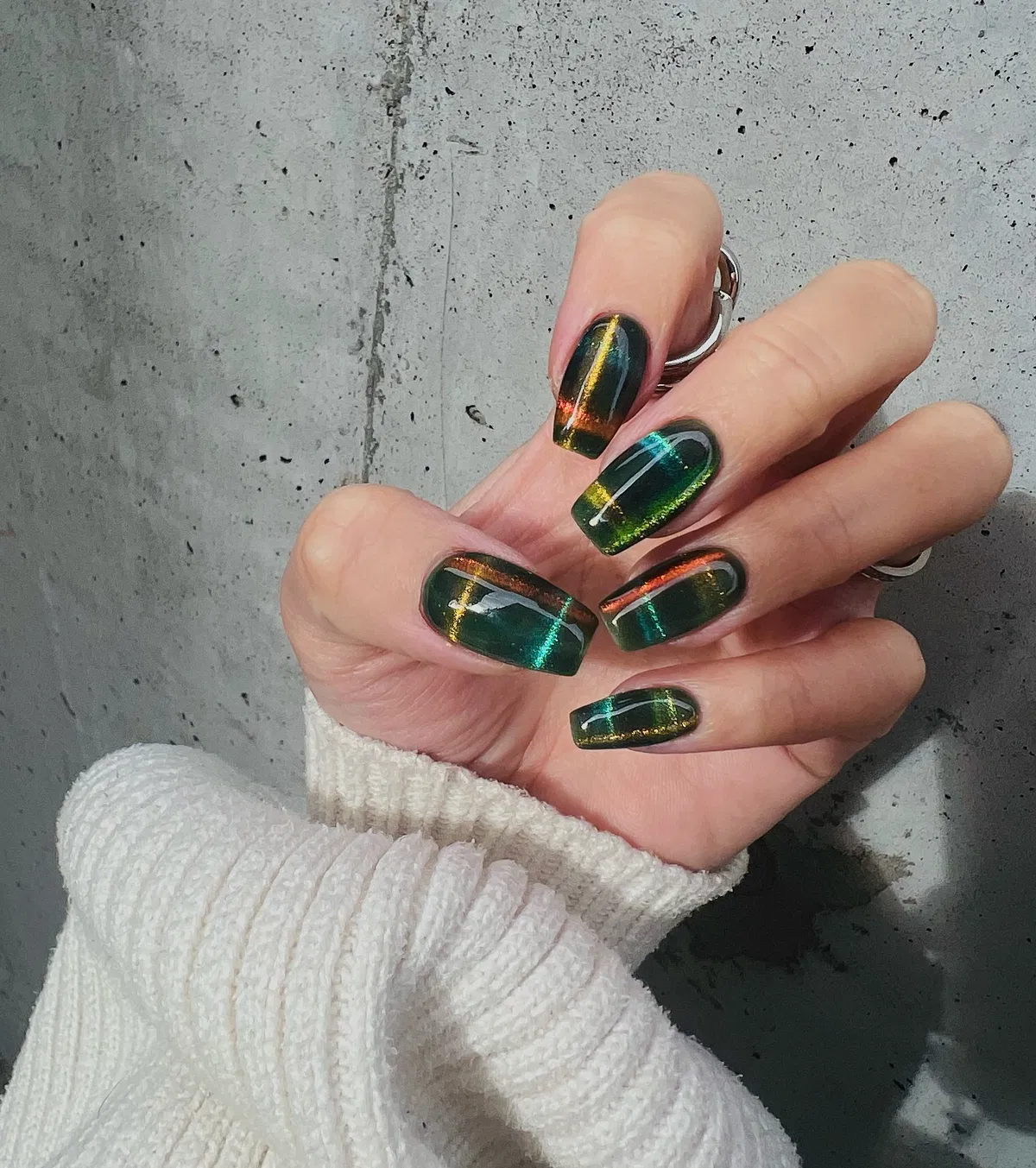 Dark green nails with iridescent vertical stripes