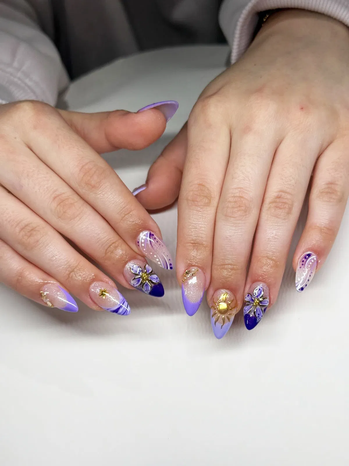 Lavender and deep purple mix with gold sun detail and floral accents
