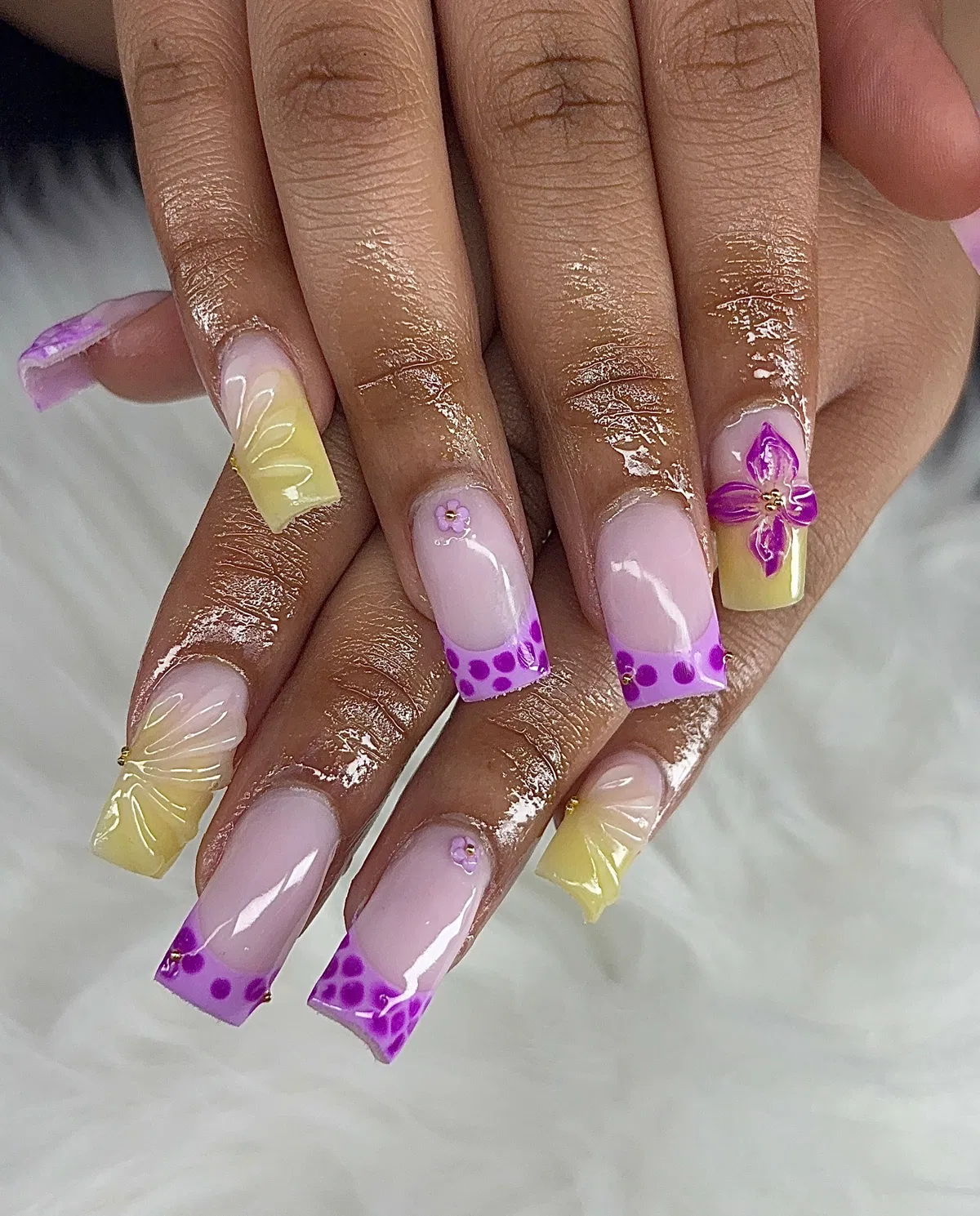 Textured pale yellow with purple dotted French tips and flower accent