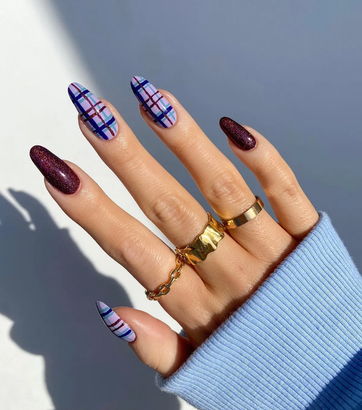 Lavender plaid accents paired with deep glittery burgundy-purple nails