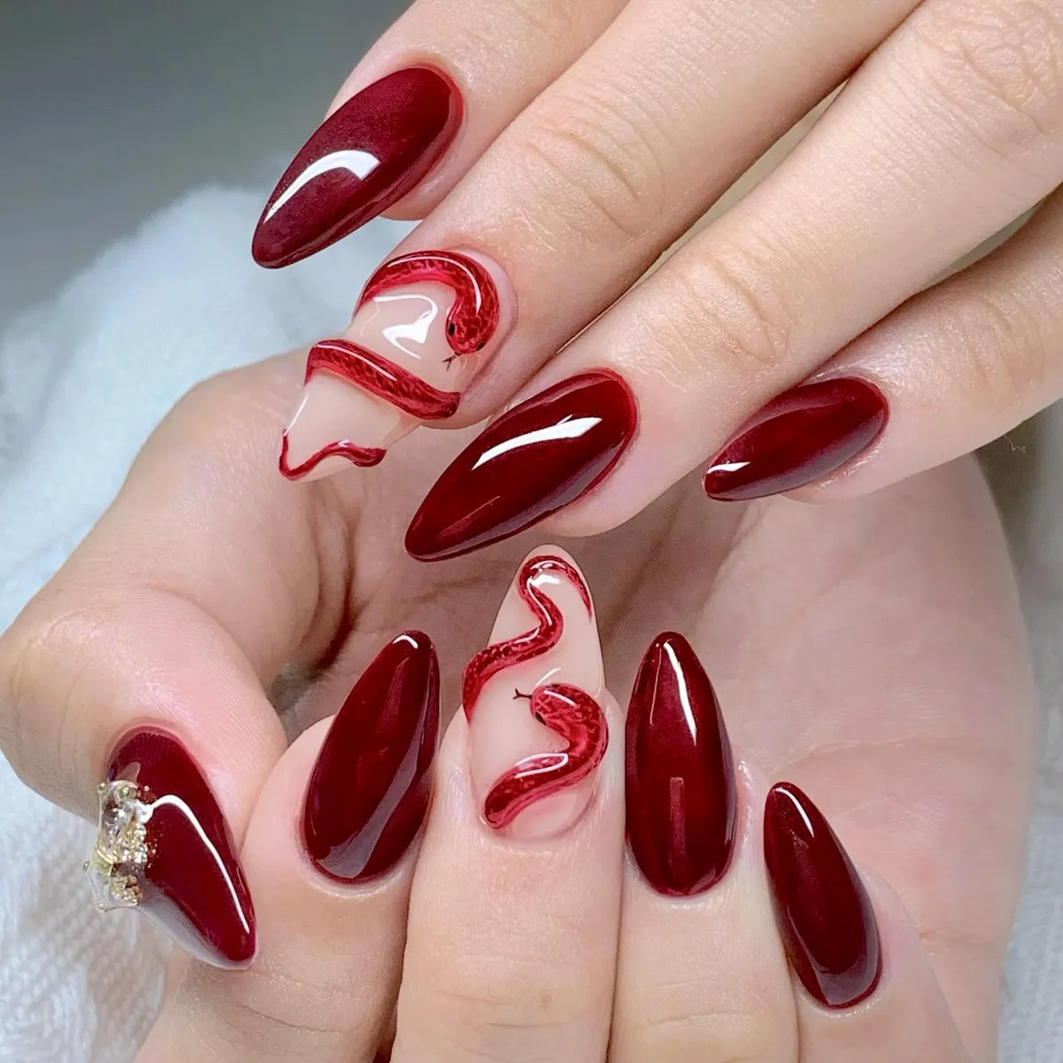 Deep burgundy set with raised red snake-like accents
