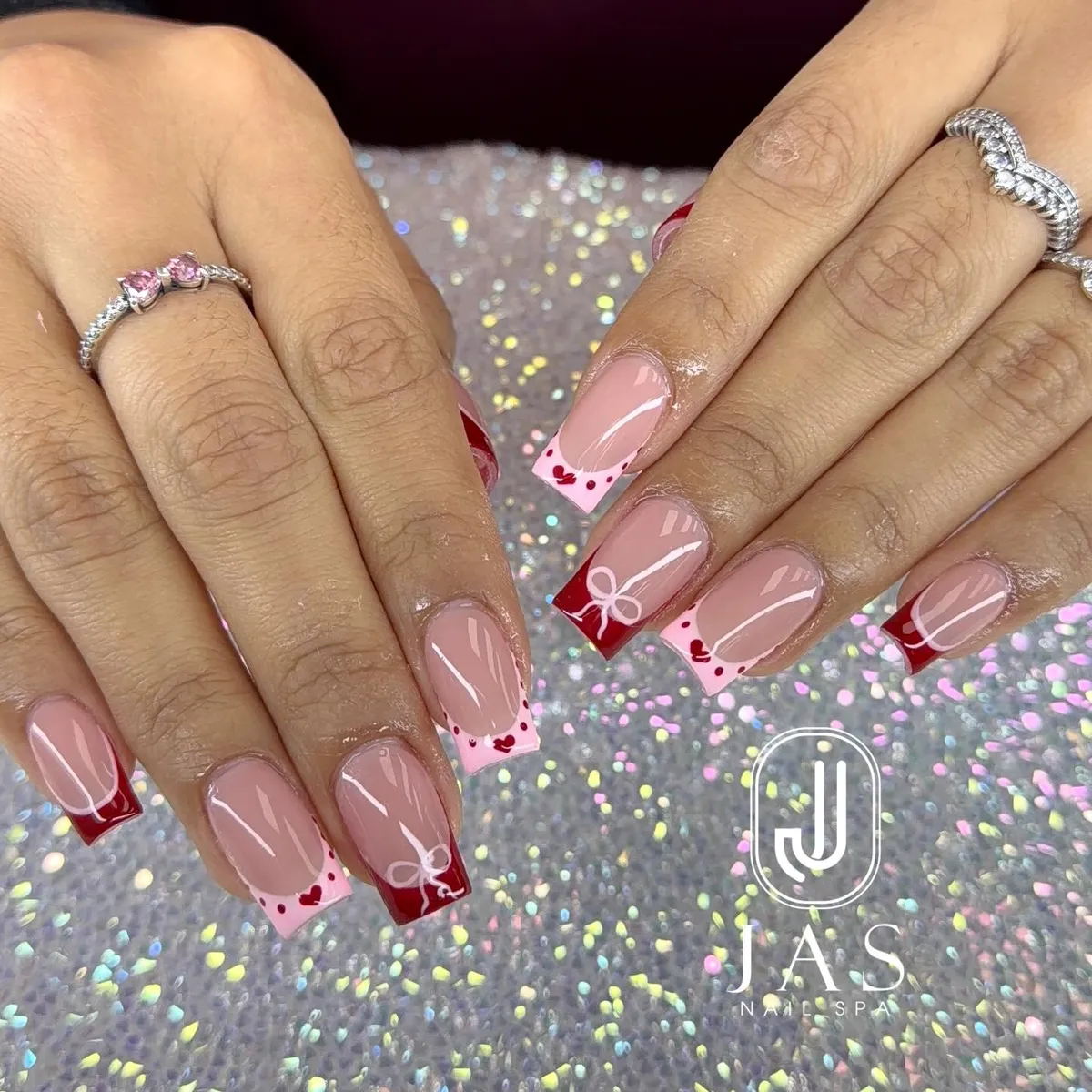 Square French tips with bow line art, hearts, and dotted edges