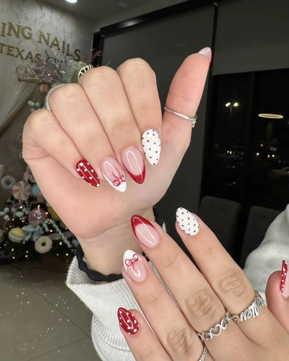 Mixed red French tips, polka dots, and bow accents