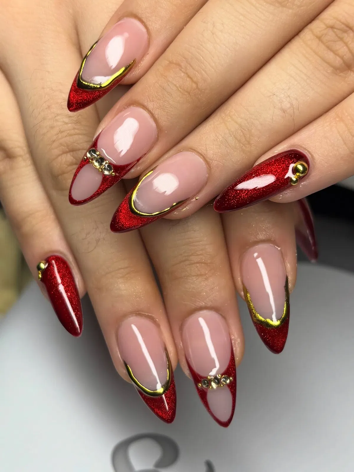 Pink base with red glitter French tips and gold/rhinestone accents
