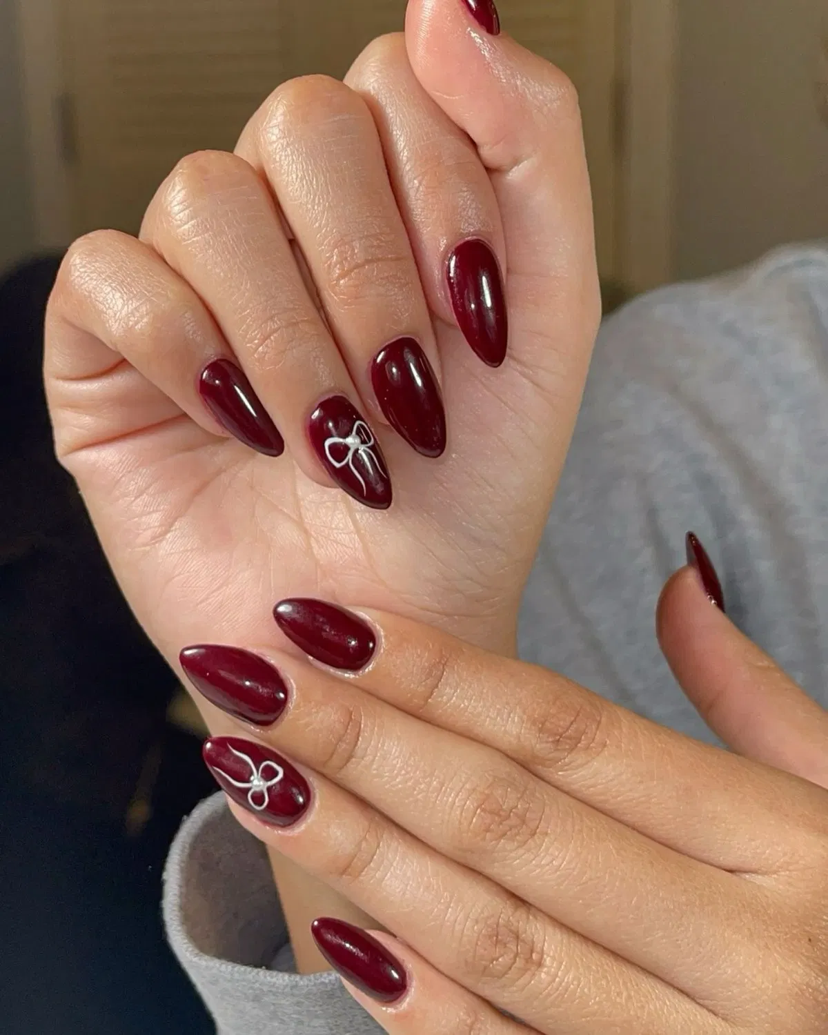 Glossy deep burgundy with minimal white bow accents