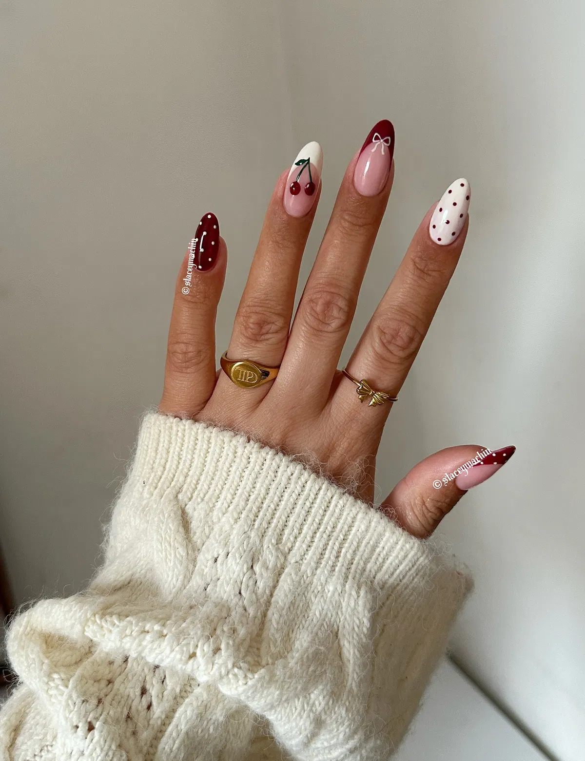 Mixed red-and-white dots, bows, and cherry nail art