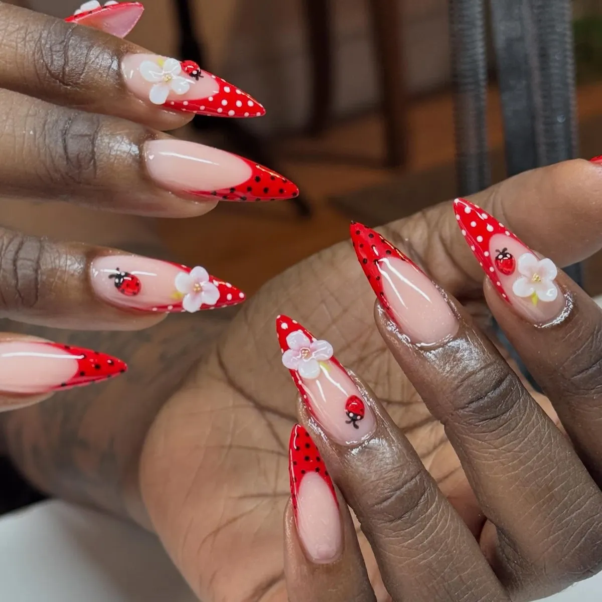 Red polka-dot stiletto tips with ladybug and flower details
