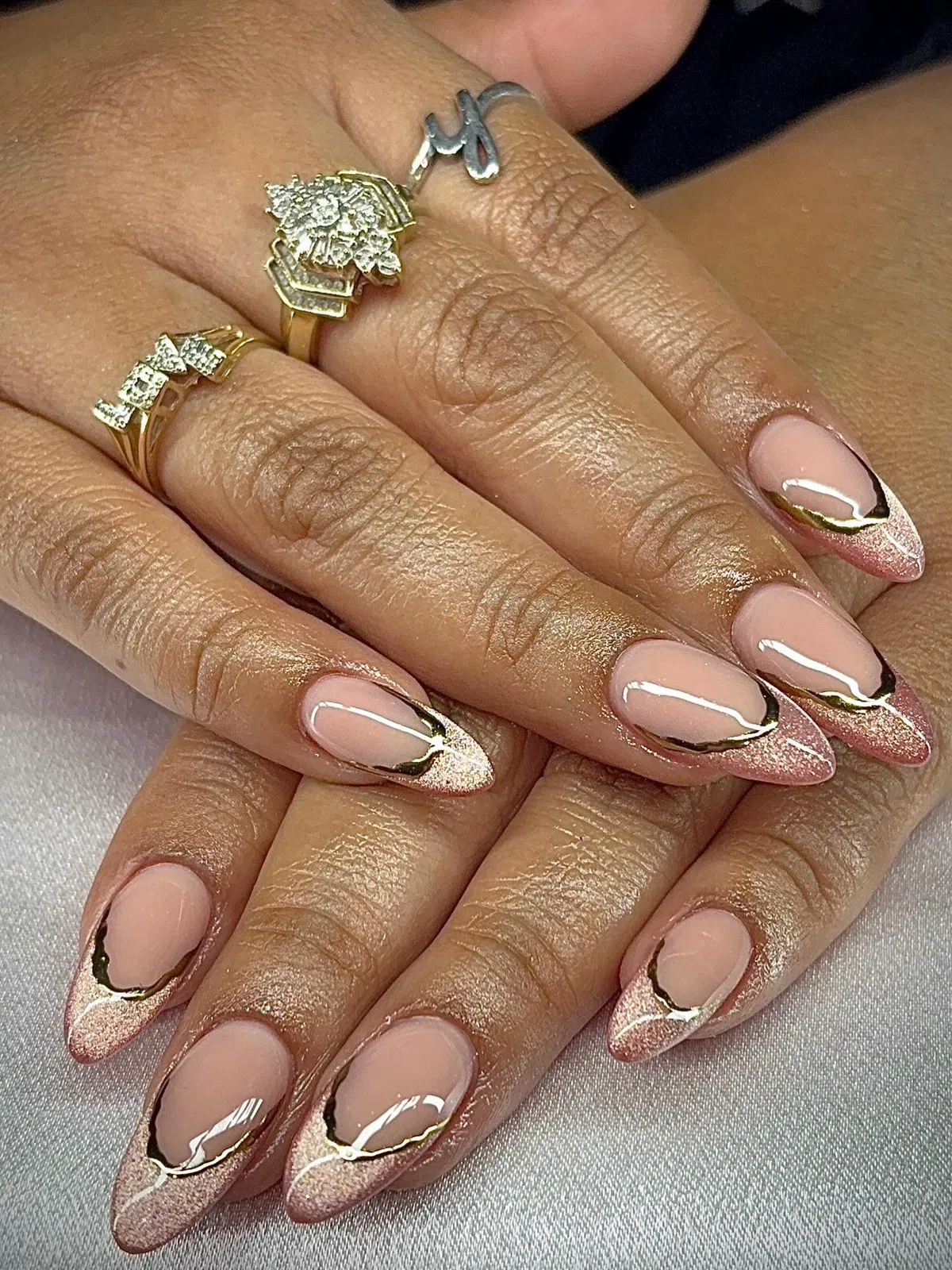 Rose-gold glitter French tips with gold outline on nude pink base