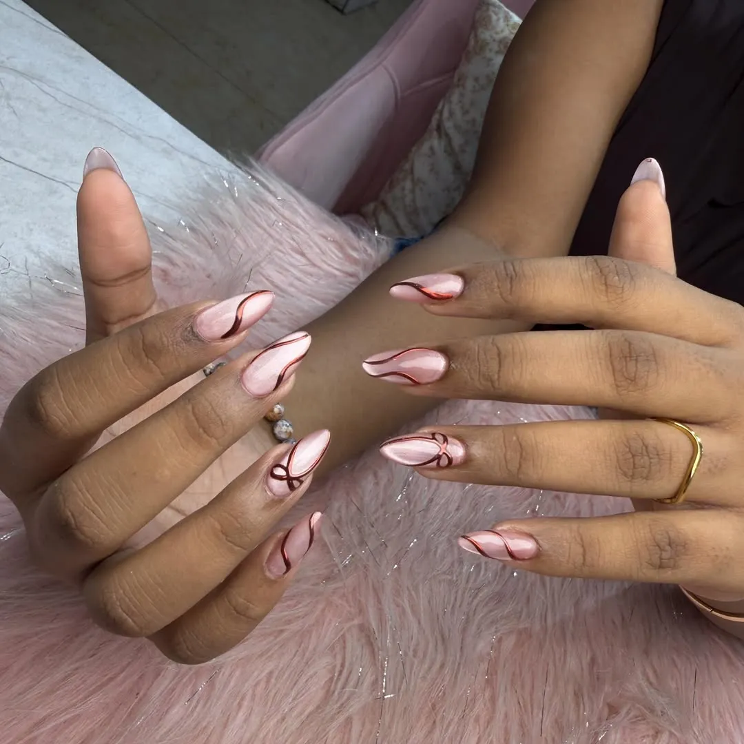 Pale pink almond nails with burgundy wavy line art
