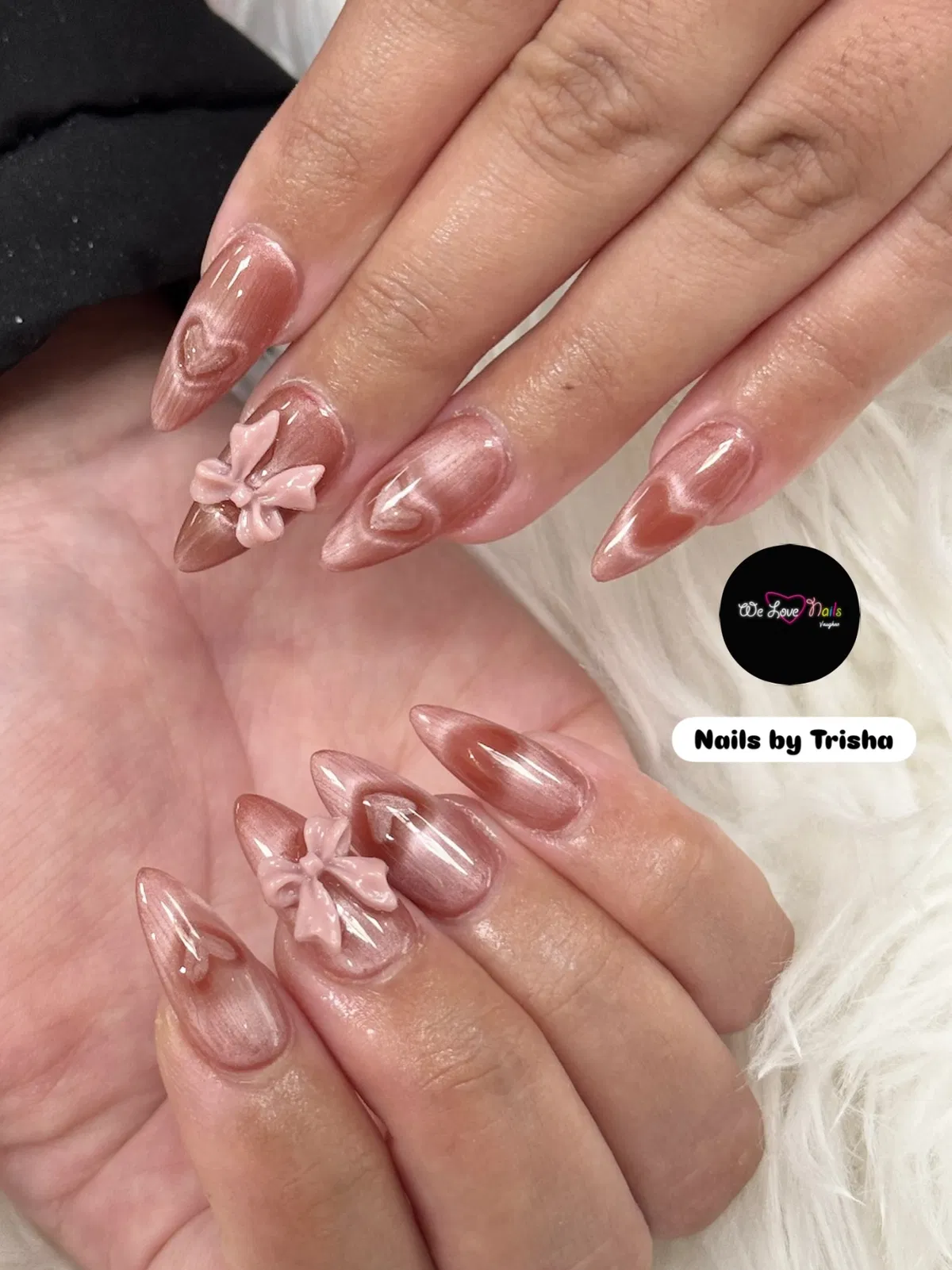 Glossy rose-pink metallic nails with 3D bows