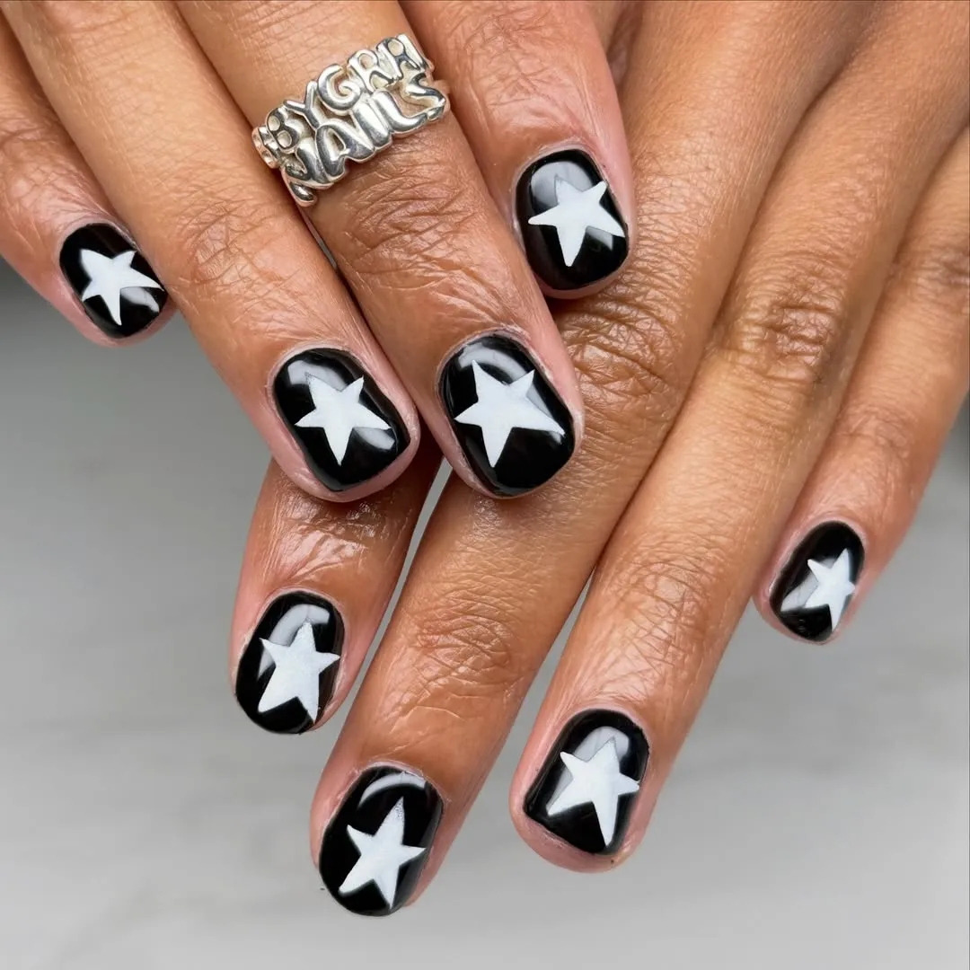 Glossy black nails with white stars