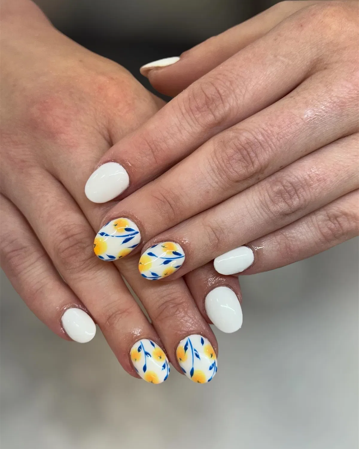 White short nails with yellow-and-blue floral accents