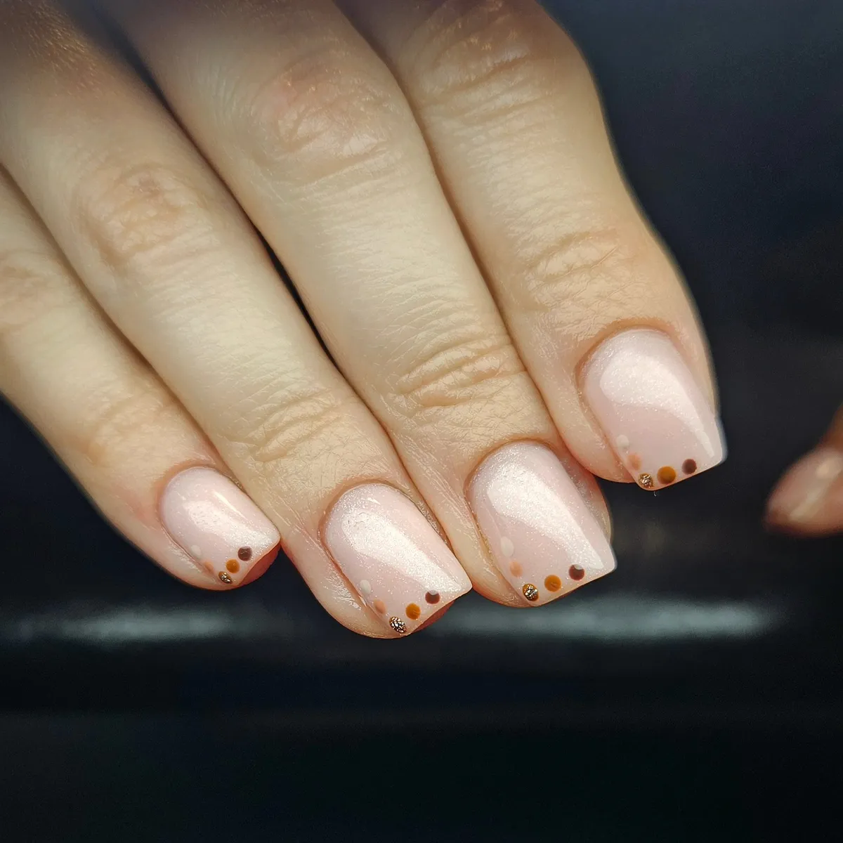 Pale pink shimmer with tiny brown/orange dot accents