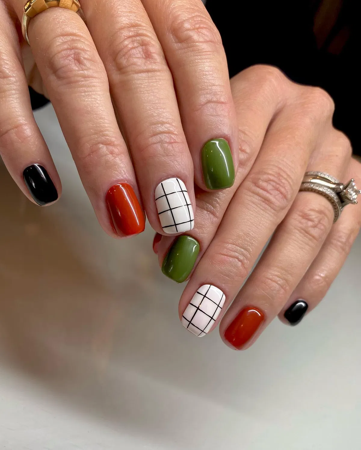 Olive, burnt orange, and black with white grid accents