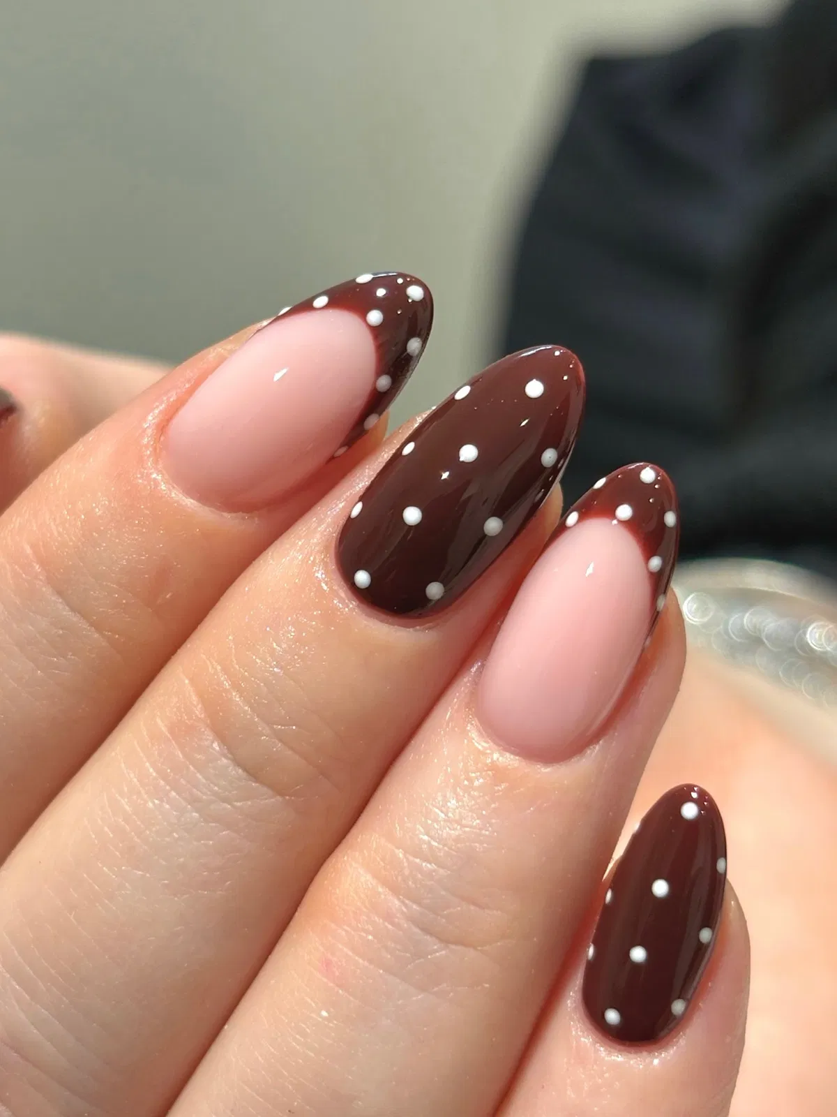 Dark brown polka dots with sheer pink French-tip contrast