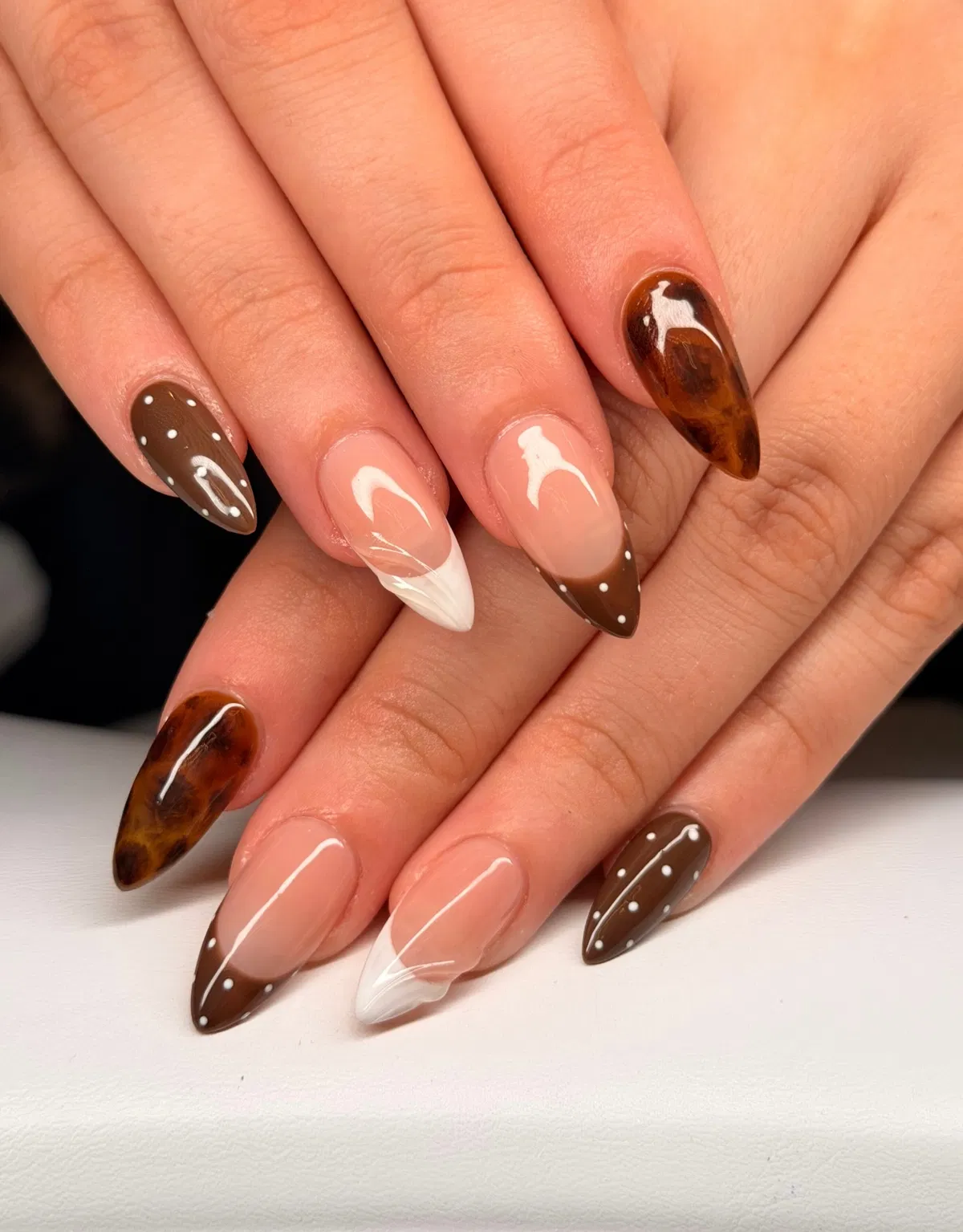 Nude and brown French tips with dots and marbled accents