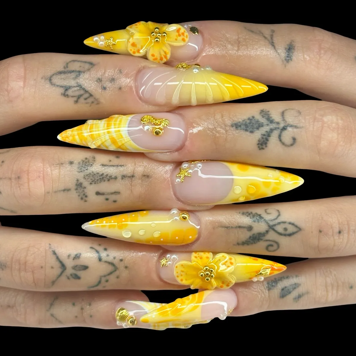 Extra-long yellow stiletto set with gold charms and raised flowers