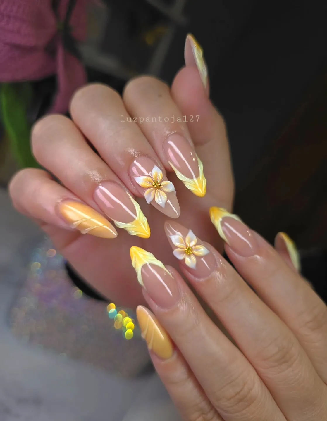 Soft yellow-tipped almond nails with raised white flowers